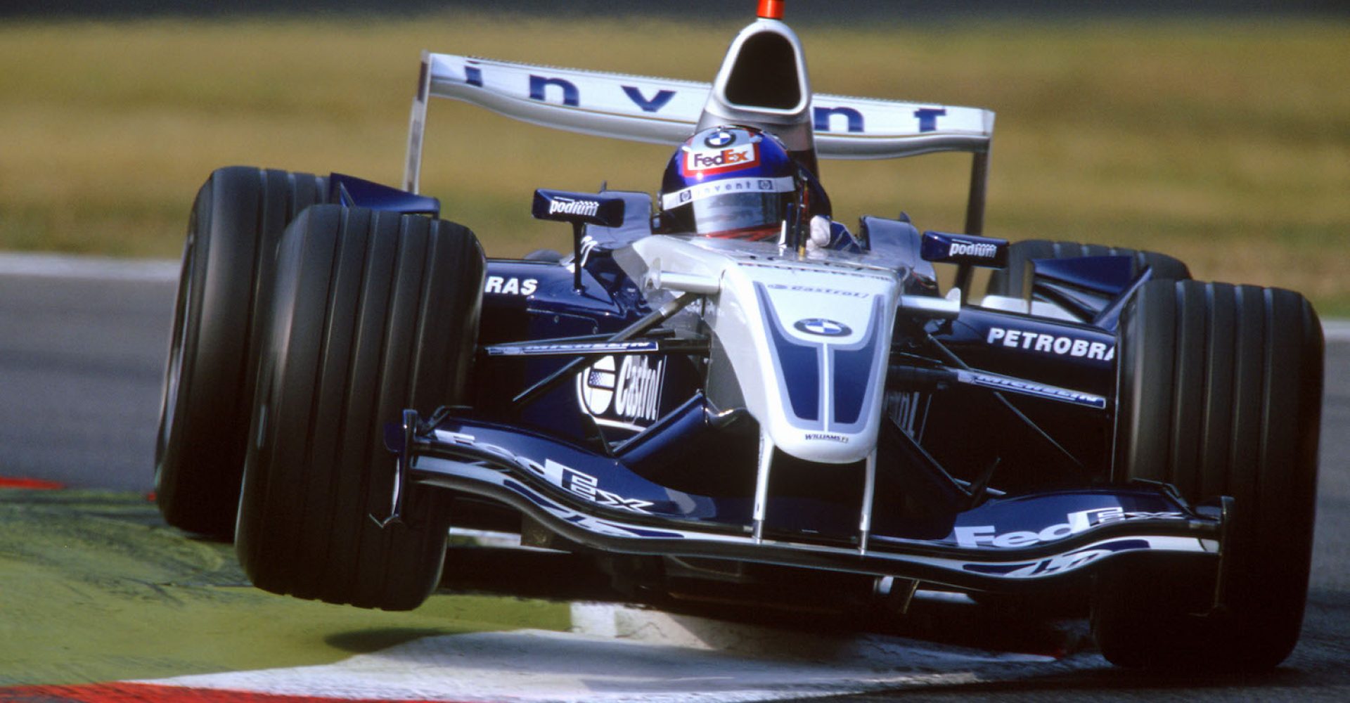 2004 Italian Grand Prix.
Monza Italy 10th - 12th September 2004.
Juan Pablo Montoya, WilliamsF1 BMW FW26 bounces over the Monza kerbs. Action.
Photo: LAT Photographic . 
Ref: 04mon08