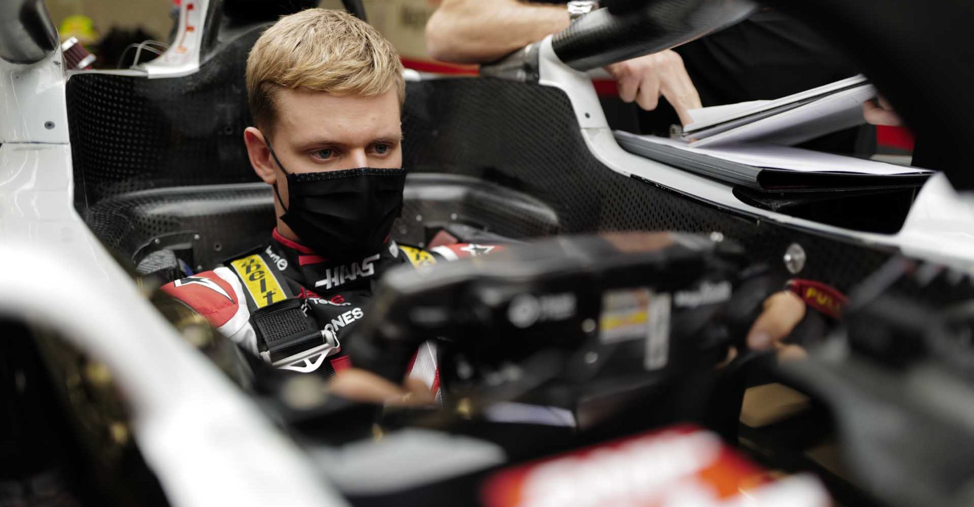 BAHRAIN INTERNATIONAL CIRCUIT, BAHRAIN - DECEMBER 02: Mick Schumacher sits in his Haas VF-20 for his seat fitting with race engineer Gary Gannon during the Sakhir GP at Bahrain International Circuit on Wednesday December 02, 2020 in Sakhir, Bahrain. (Photo by Andy Hone / LAT Images)