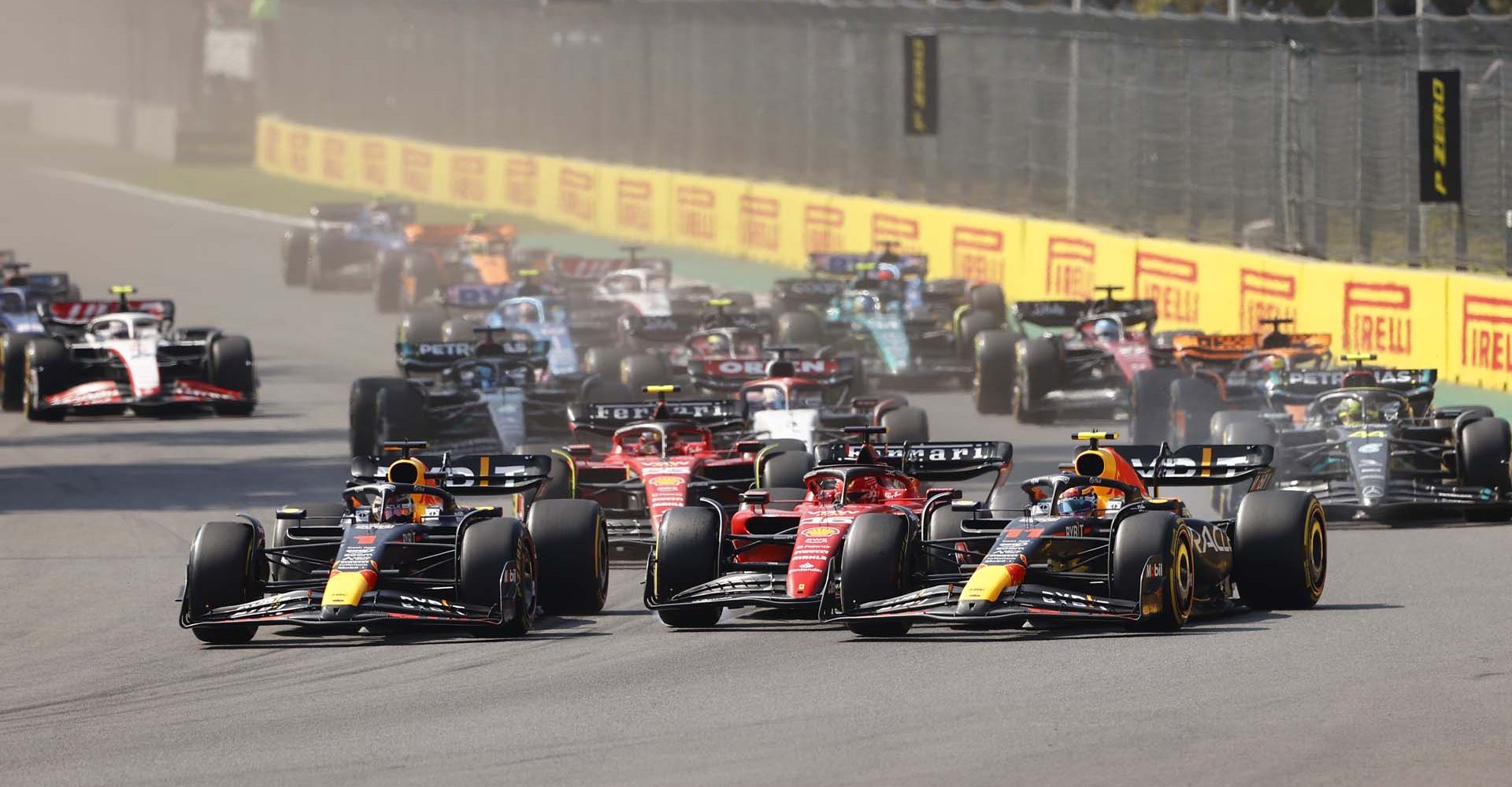 AUTODROMO HERMANOS RODRIGUEZ, MEXICO - OCTOBER 29: Max Verstappen, Red Bull Racing RB19, leads Charles Leclerc, Ferrari SF-23, Sergio Perez, Red Bull Racing RB19, Carlos Sainz, Ferrari SF-23, Sir Lewis Hamilton, Mercedes F1 W14, George Russell, Mercedes F1 W14, and the rest of the field at the start during the Mexico City GP at Autodromo Hermanos Rodriguez on Sunday October 29, 2023 in Mexico City, Mexico. (Photo by Andy Hone / LAT Images)