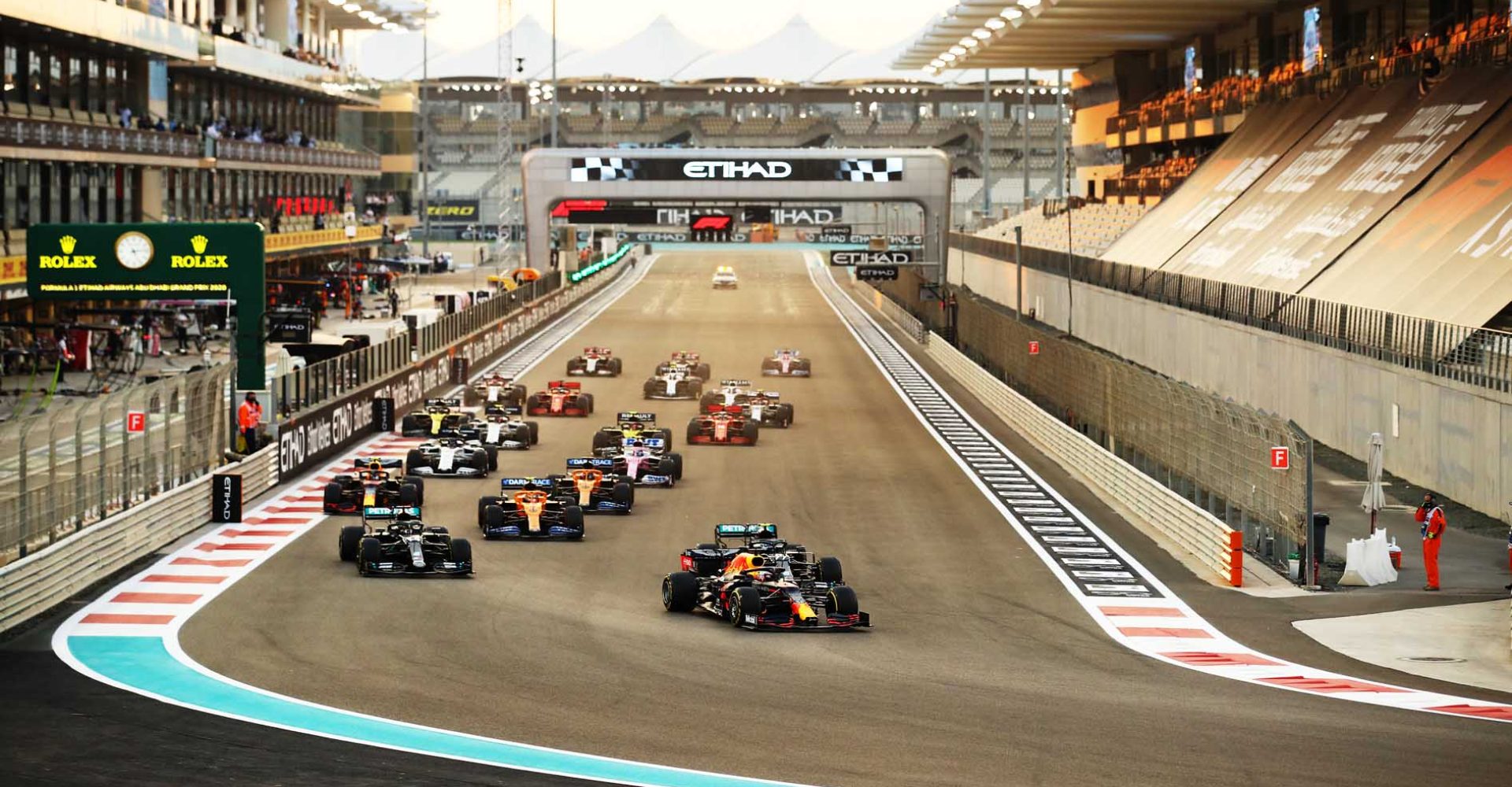 ABU DHABI, UNITED ARAB EMIRATES - DECEMBER 13: Max Verstappen of the Netherlands driving the (33) Aston Martin Red Bull Racing RB16 leads Lewis Hamilton of Great Britain driving the (44) Mercedes AMG Petronas F1 Team Mercedes W11 and Valtteri Bottas of Finland driving the (77) Mercedes AMG Petronas F1 Team Mercedes W11 into turn one at the start during the F1 Grand Prix of Abu Dhabi at Yas Marina Circuit on December 13, 2020 in Abu Dhabi, United Arab Emirates. (Photo by Bryn Lennon/Getty Images)