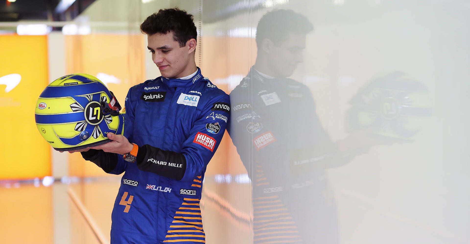 Lando Norris, McLaren, admires his crash helmet