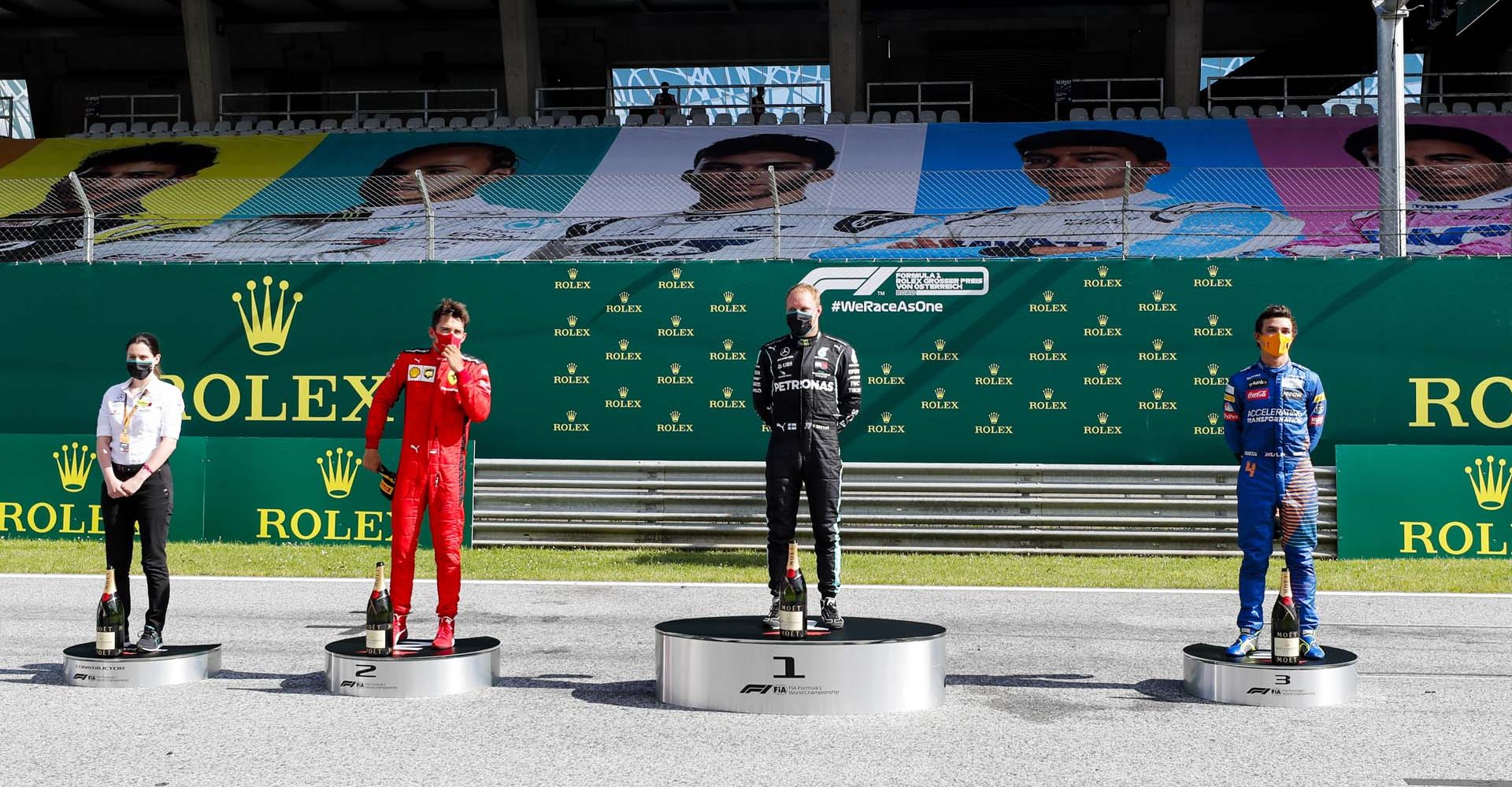 JULY 05: Mercedes Team Member, Charles Leclerc, Ferrari, race winner Valtteri Bottas, Mercedes-AMG Petronas F1 and Lando Norris, McLaren on the podium during the Austrian GP on Sunday July 05, 2020. (Photo by Steven Tee / LAT Images)