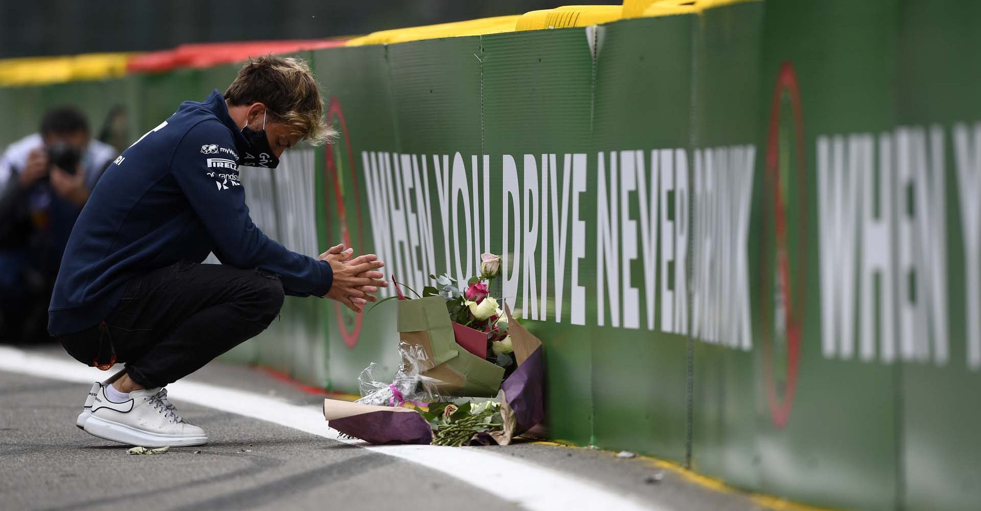 SPA, BELGIUM - AUGUST 27: Pierre Gasly of France and Scuderia AlphaTauri leaves flowers at the side of the track in tribute to the late Formula 2 driver Anthoine Hubert, who passed at this race in 2019 during previews ahead of the F1 Grand Prix of Belgium at Circuit de Spa-Francorchamps on August 27, 2020 in Spa, Belgium. (Photo by Rudy Carezzevoli/Getty Images) // Getty Images / Red Bull Content Pool  // SI202008270289 // Usage for editorial use only //