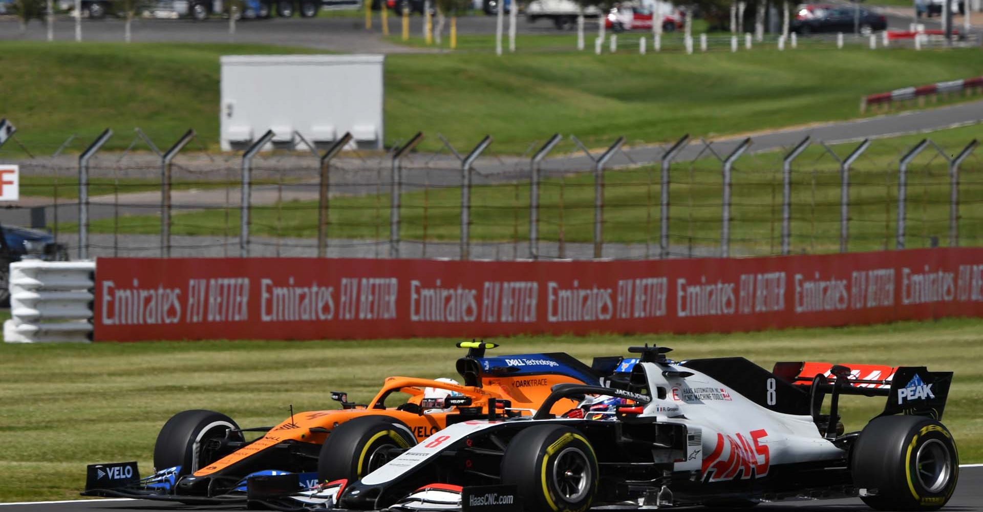 SILVERSTONE, UNITED KINGDOM - AUGUST 02: Lando Norris, McLaren MCL35, battles with Romain Grosjean, Haas VF-20 during the British GP at Silverstone on Sunday August 02, 2020 in Northamptonshire, United Kingdom. (Photo by Mark Sutton / LAT Images)