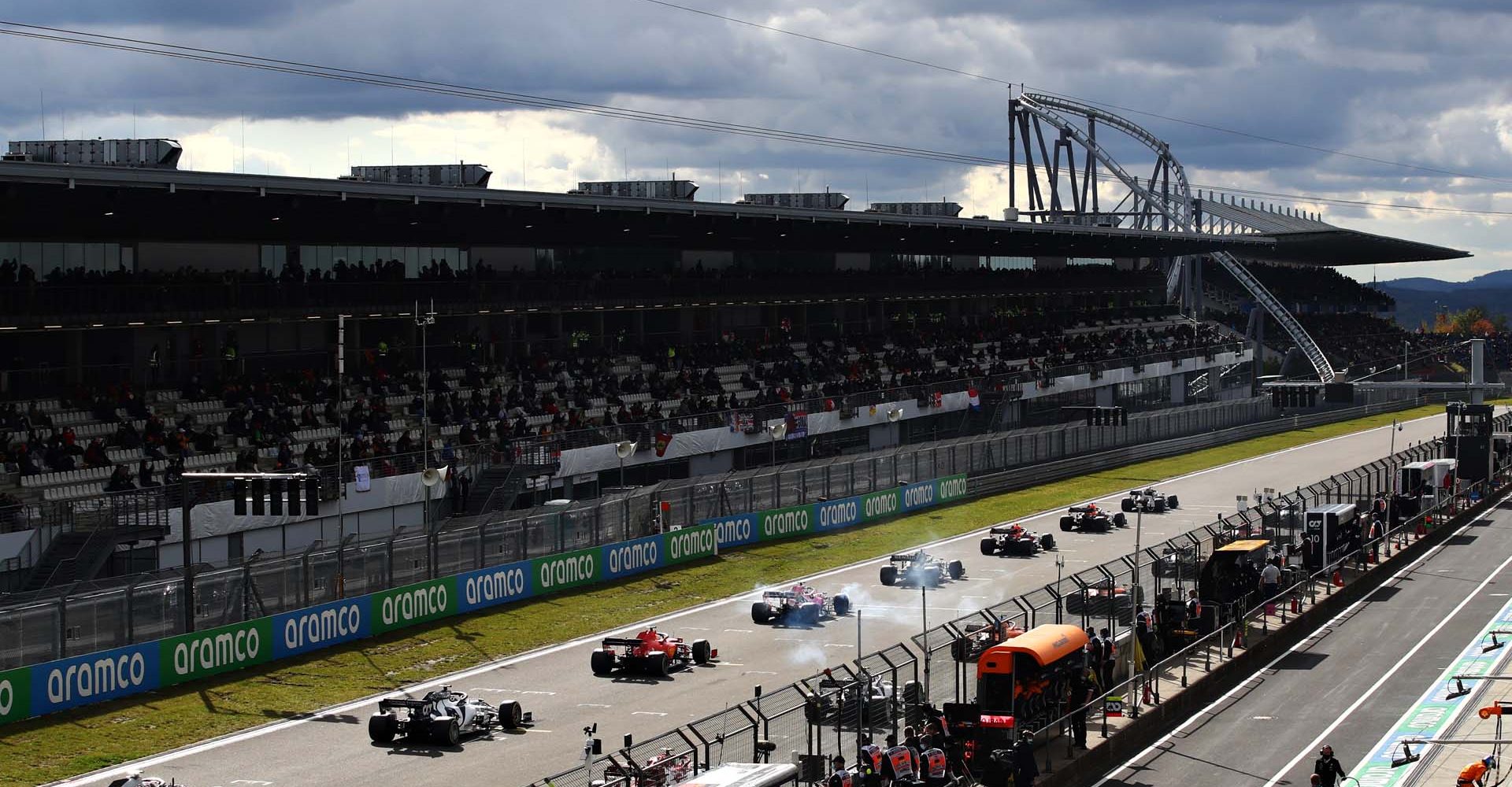 NUERBURG, GERMANY - OCTOBER 11: Daniil Kvyat of Russia driving the (26) Scuderia AlphaTauri AT01 Honda leads Kevin Magnussen of Denmark driving the (20) Haas F1 Team VF-20 Ferrari at the start during the F1 Eifel Grand Prix at Nuerburgring on October 11, 2020 in Nuerburg, Germany. (Photo by Mark Thompson/Getty Images)