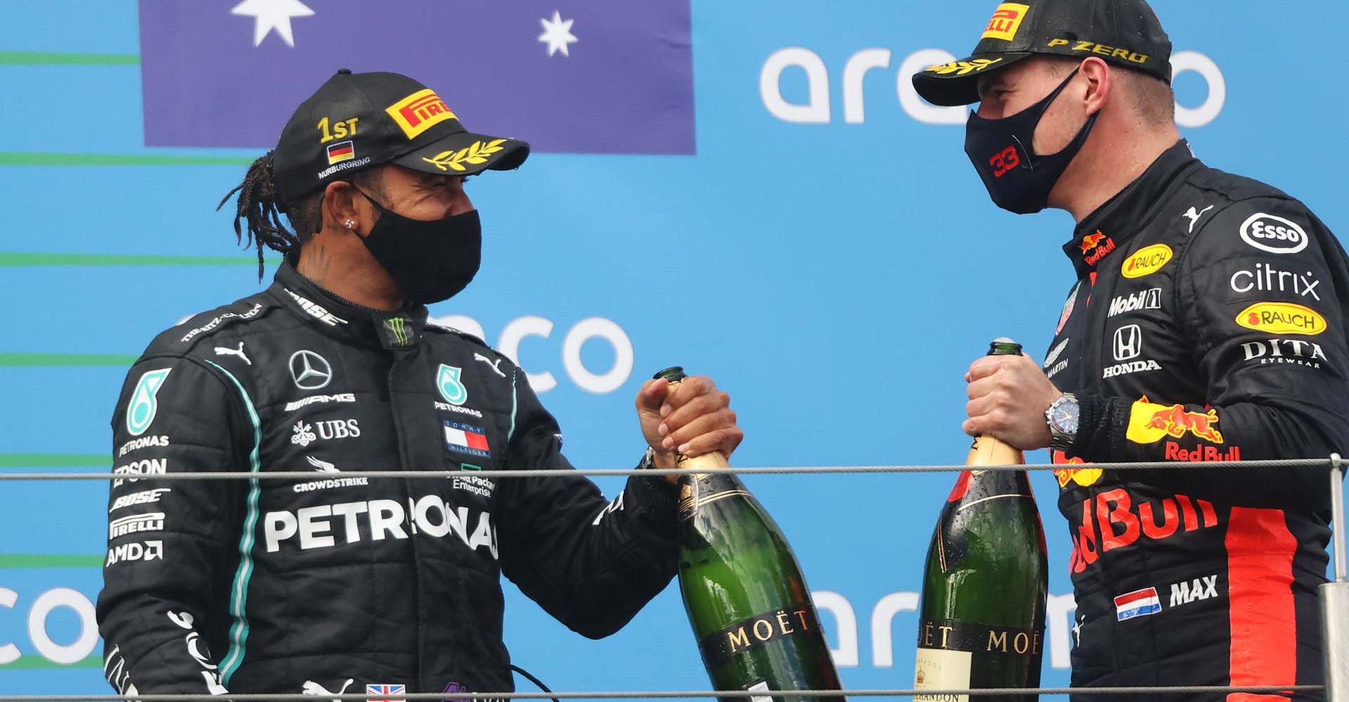 NUERBURG, GERMANY - OCTOBER 11: Race winner Lewis Hamilton of Great Britain and Mercedes GP and second placed Max Verstappen of Netherlands and Red Bull Racing celebrate on the podium during the F1 Eifel Grand Prix at Nuerburgring on October 11, 2020 in Nuerburg, Germany. (Photo by Wolfgang Rattay - Pool/Getty Images)