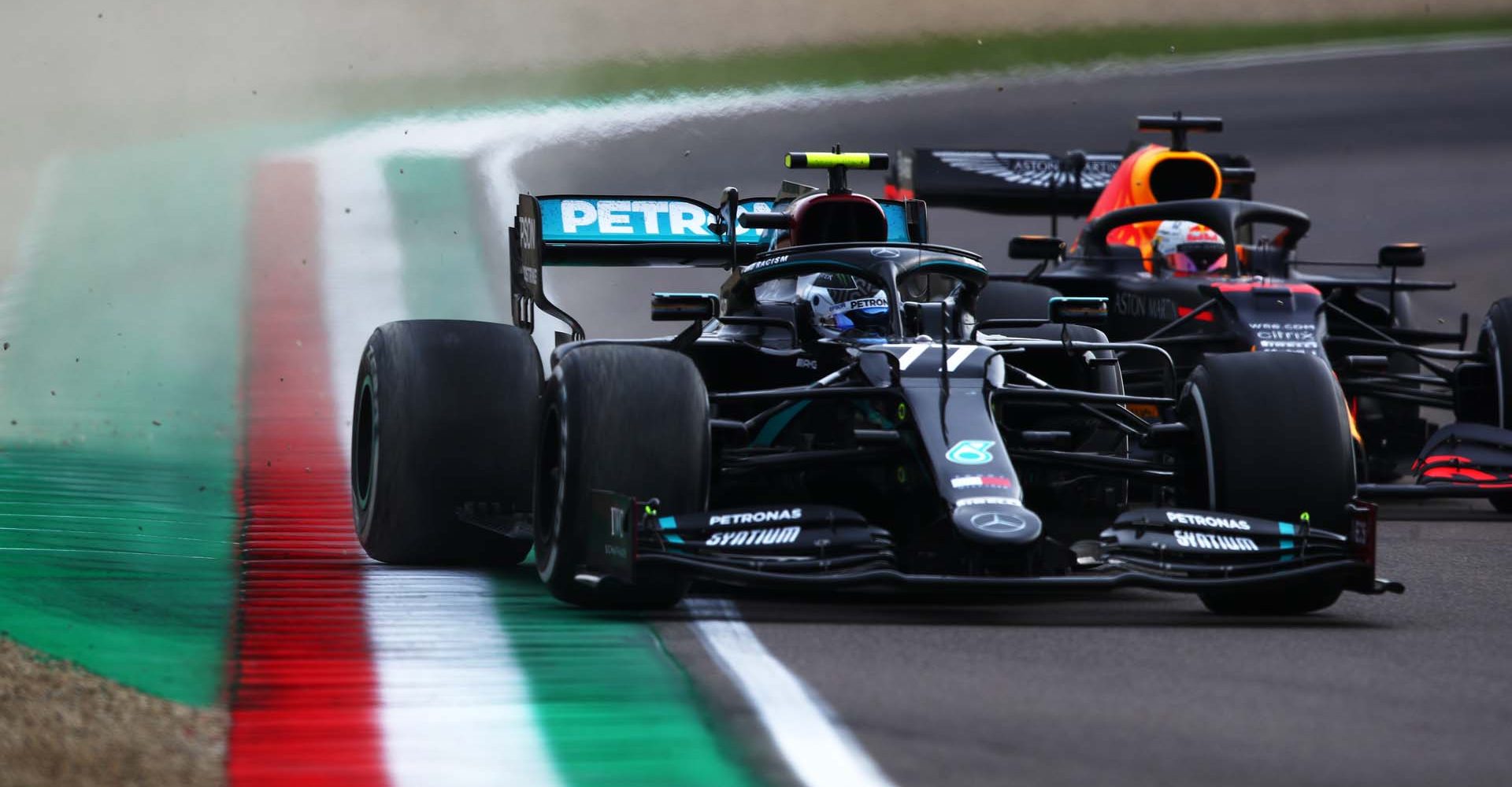 IMOLA, ITALY - NOVEMBER 01: Valtteri Bottas of Finland driving the (77) Mercedes AMG Petronas F1 Team Mercedes W11 leads Max Verstappen of the Netherlands driving the (33) Aston Martin Red Bull Racing RB16 on track during the F1 Grand Prix of Emilia Romagna at Autodromo Enzo e Dino Ferrari on November 01, 2020 in Imola, Italy. (Photo by Joe Portlock/Getty Images)