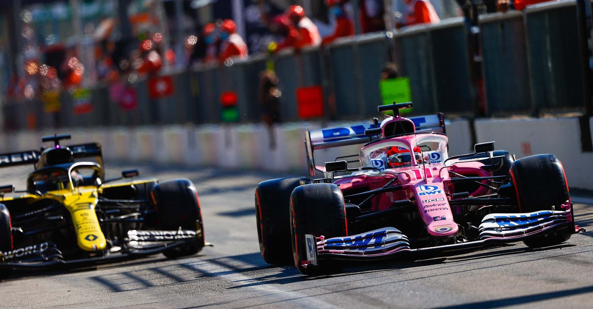 Sergio Perez, Racing Point RP20, leads Daniel Ricciardo, Renault R.S.20, in the pit lane