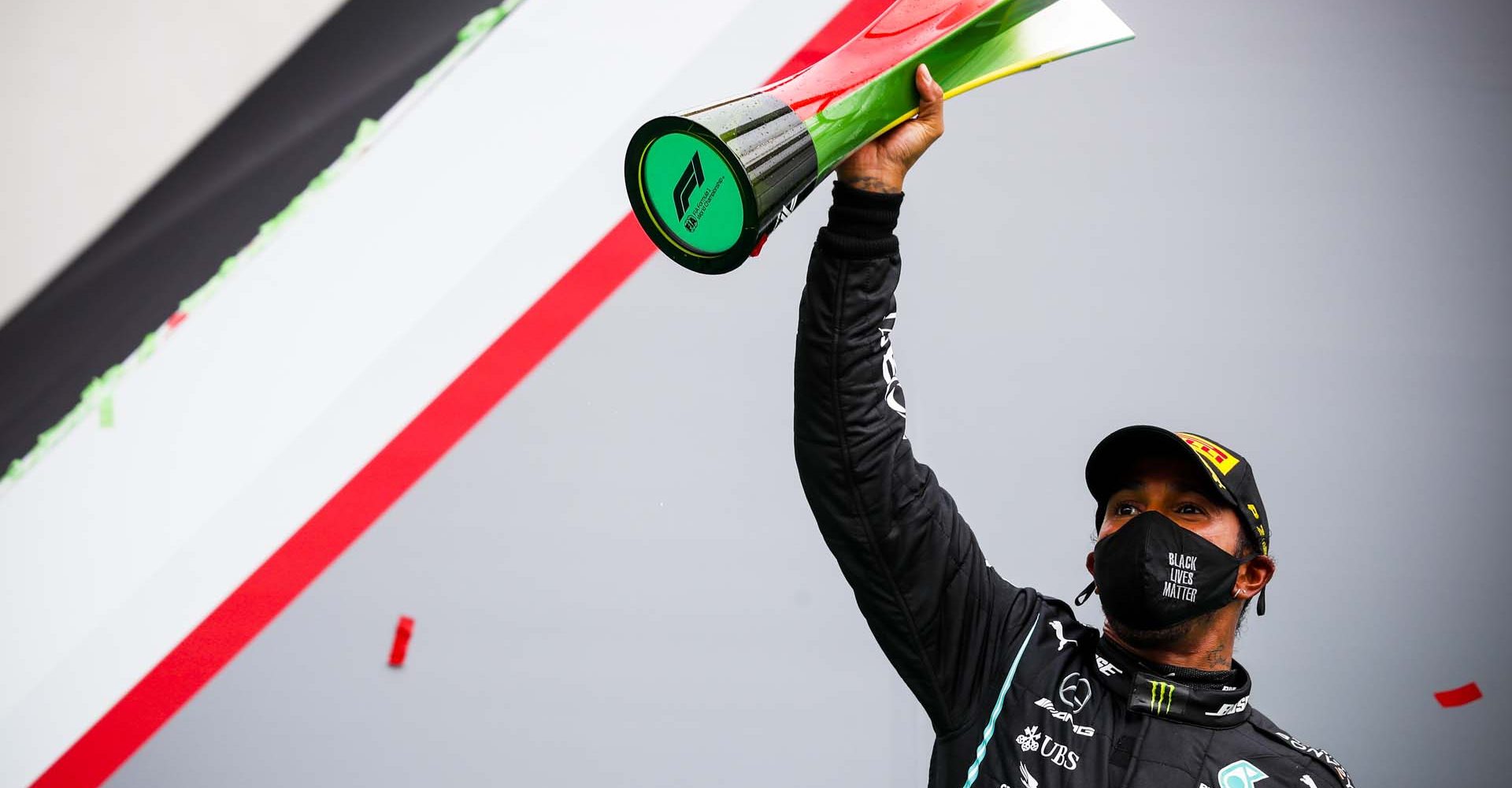 ALGARVE INTERNATIONAL CIRCUIT, PORTUGAL - OCTOBER 25: Race Winner Lewis Hamilton, Mercedes F1 celebrates on the podium with the trophy after taking his 92nd Grand Prix win, the most for any driver in F1 history during the Portuguese GP at Algarve International Circuit on Sunday October 25, 2020, Portugal. (Photo by Sam Bloxham / LAT Images)