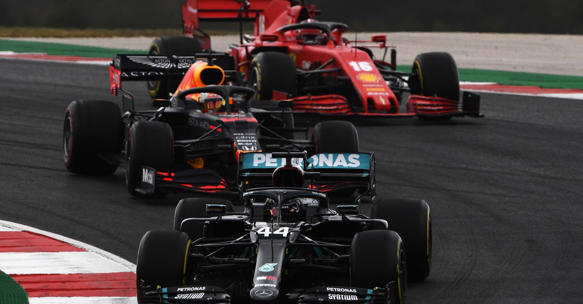 PORTIMAO, PORTUGAL - OCTOBER 25: Lewis Hamilton of Great Britain driving the (44) Mercedes AMG Petronas F1 Team Mercedes W11 leads Max Verstappen of the Netherlands driving the (33) Aston Martin Red Bull Racing RB16 and Charles Leclerc of Monaco driving the (16) Scuderia Ferrari SF1000  during the F1 Grand Prix of Portugal at Autodromo Internacional do Algarve on October 25, 2020 in Portimao, Portugal. (Photo by Rudy Carezzevoli/Getty Images)