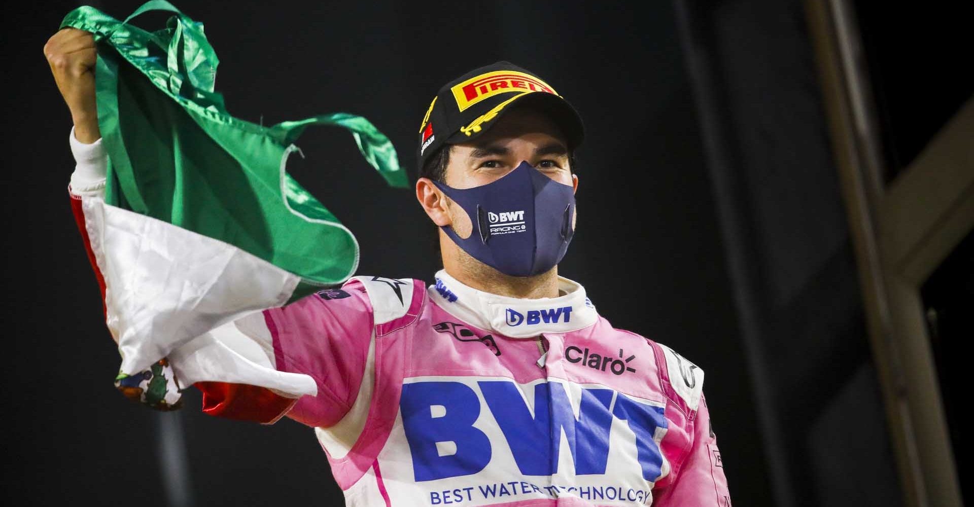 Sergio Perez, Racing Point, 1st position, celebrates with a Mexican flag on the podium