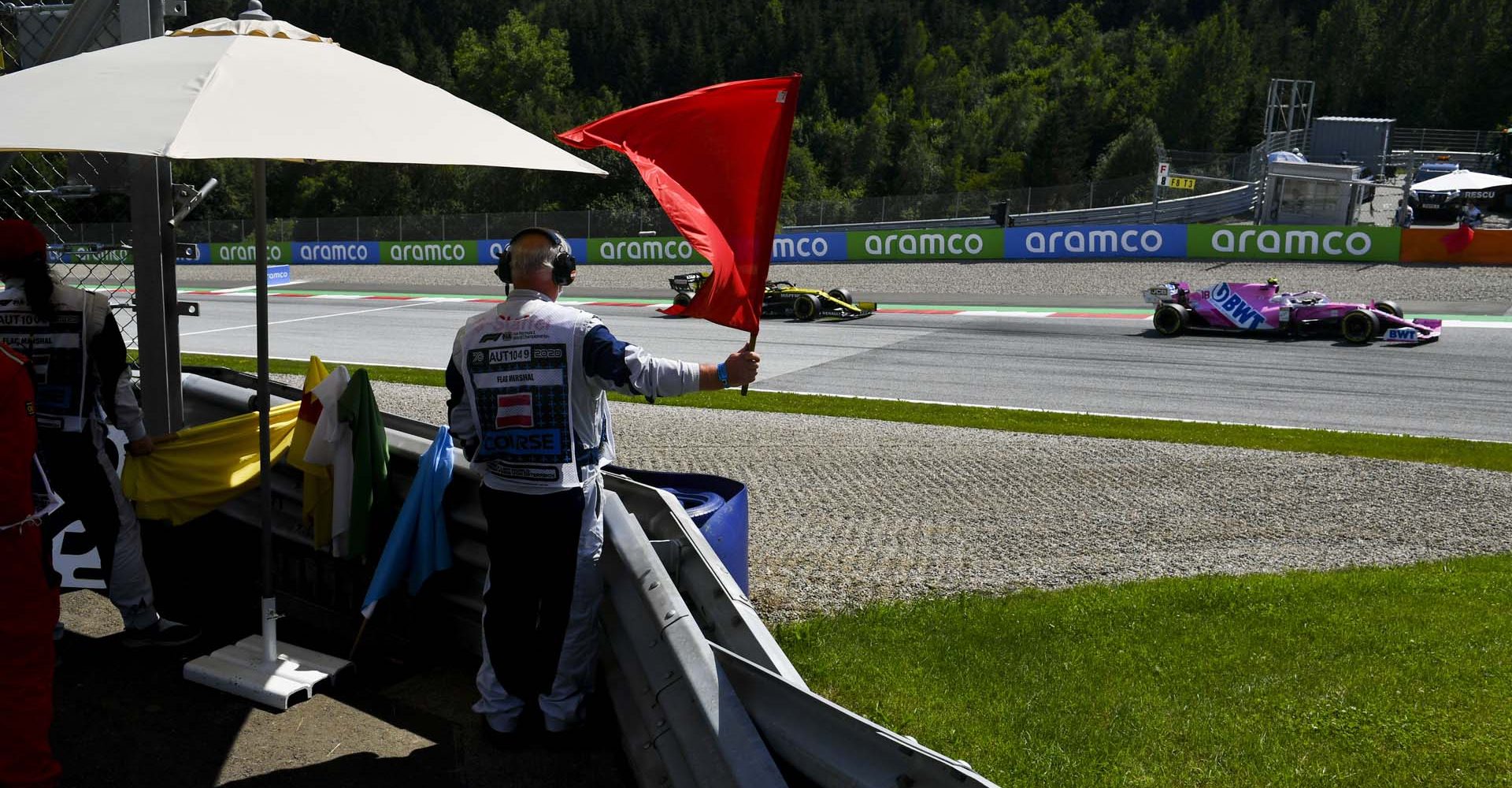 Marshal waves red flag as Lance Stroll, Racing Point RP20 passes by