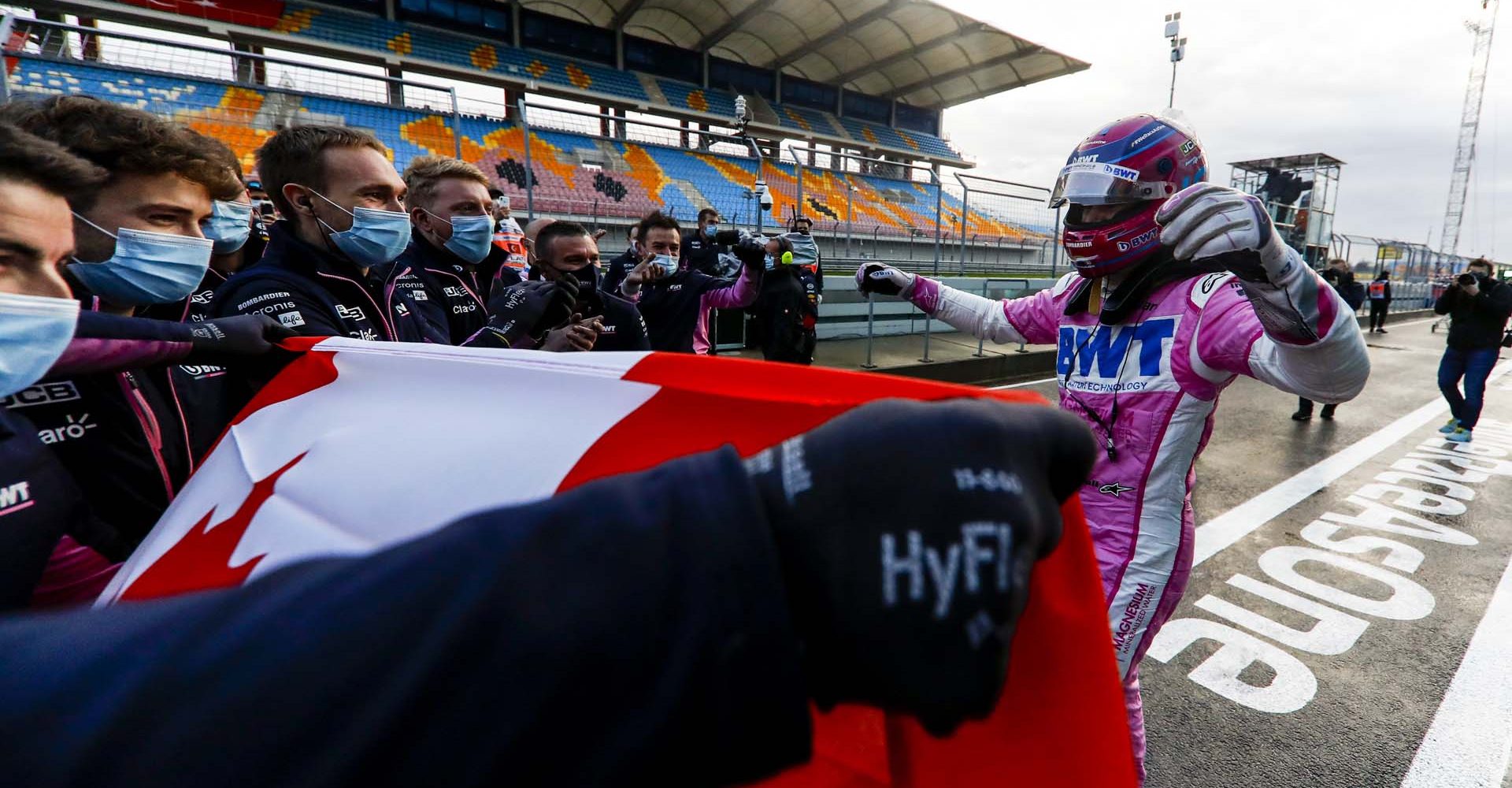 Lance Stroll, Racing Point, celebrates with his team after taking pole position