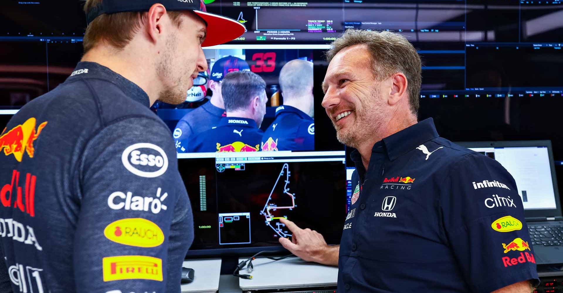 ABU DHABI, UNITED ARAB EMIRATES - DECEMBER 10: Max Verstappen of Netherlands and Red Bull Racing and Red Bull Racing Team Principal Christian Horner talk in the garage during practice ahead of the F1 Grand Prix of Abu Dhabi at Yas Marina Circuit on December 10, 2021 in Abu Dhabi, United Arab Emirates. (Photo by Mark Thompson/Getty Images)