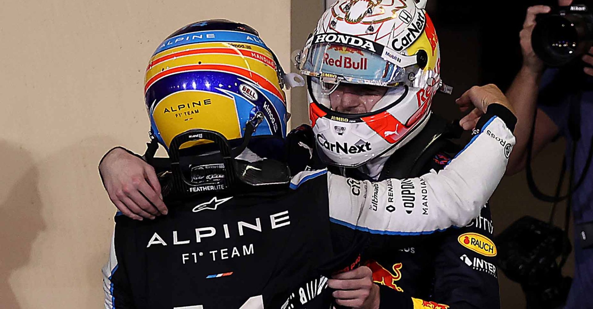 ABU DHABI, UNITED ARAB EMIRATES - DECEMBER 12: Race winner and 2021 F1 World Drivers Champion Max Verstappen of Netherlands and Red Bull Racing celebrates with Fernando Alonso of Spain and Alpine F1 Team in parc ferme during the F1 Grand Prix of Abu Dhabi at Yas Marina Circuit on December 12, 2021 in Abu Dhabi, United Arab Emirates. (Photo by Lars Baron/Getty Images)