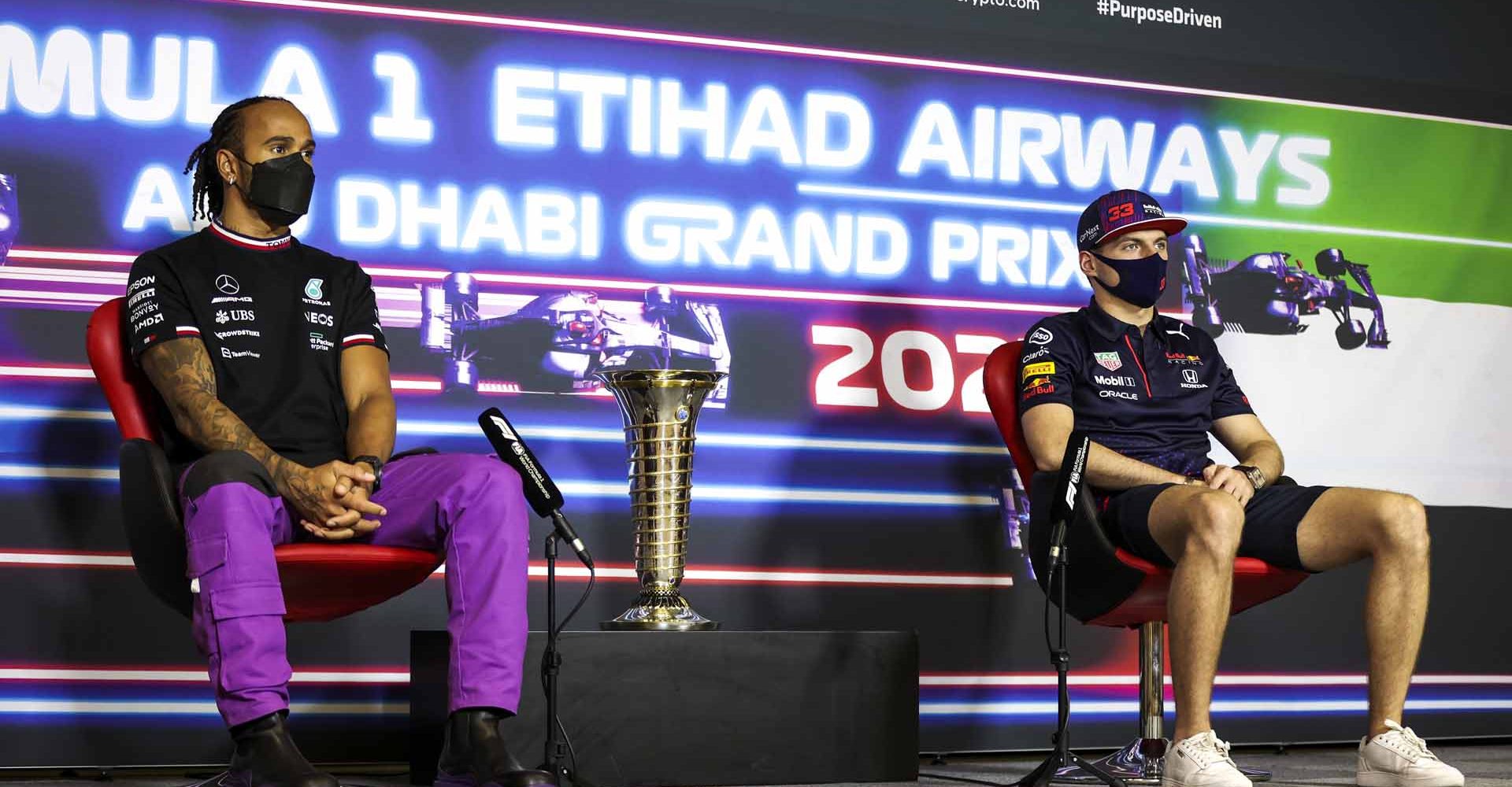 ABU DHABI, UNITED ARAB EMIRATES - DECEMBER 09: Lewis Hamilton of Great Britain and Mercedes GP and Max Verstappen of Netherlands and Red Bull Racing talk in the Drivers Press Conference during previews ahead of the F1 Grand Prix of Abu Dhabi at Yas Marina Circuit on December 09, 2021 in Abu Dhabi, United Arab Emirates. (Photo by Antonin Vincent - Pool/Getty Images)