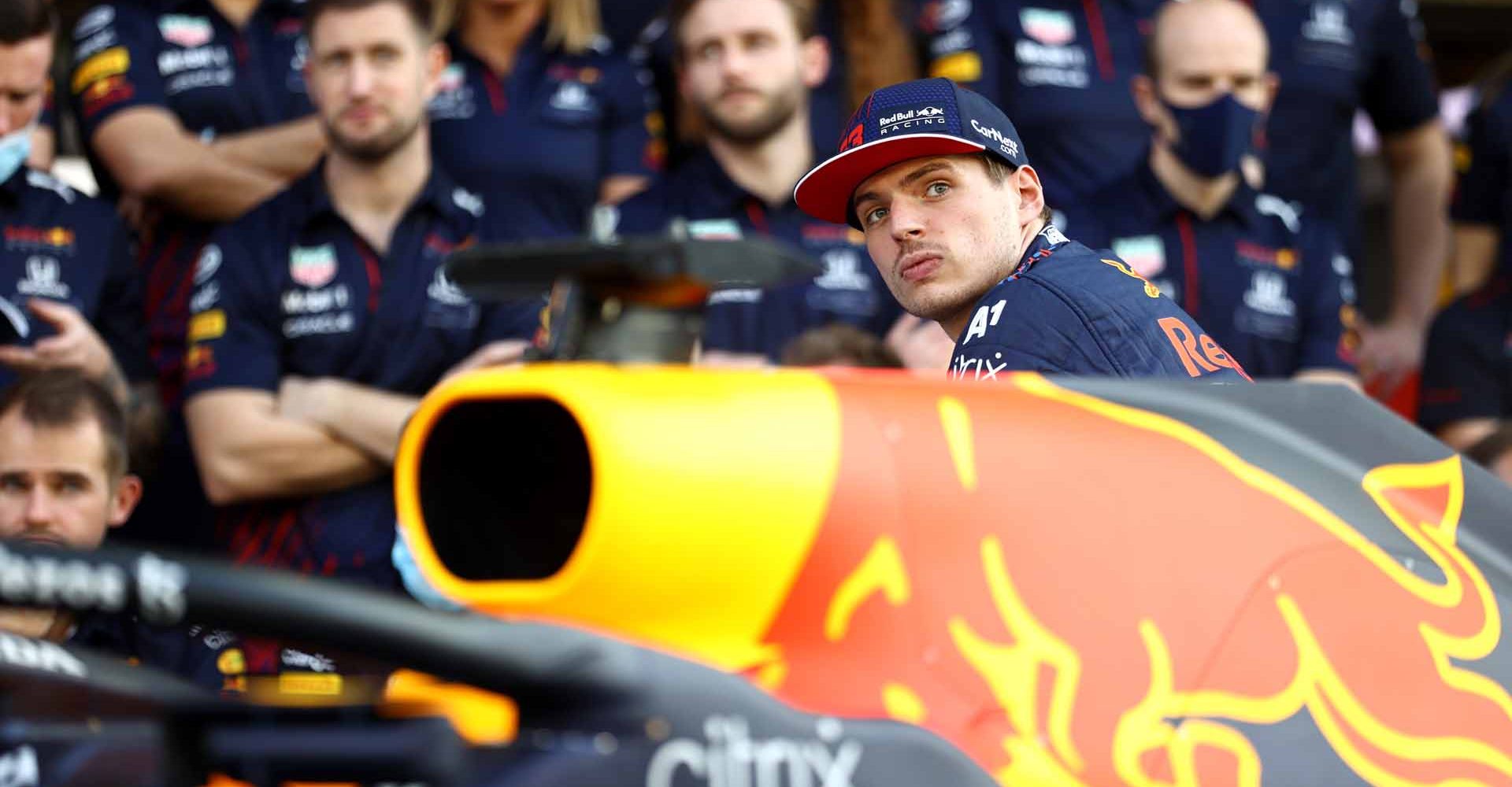 ABU DHABI, UNITED ARAB EMIRATES - DECEMBER 09: Max Verstappen of Netherlands and Red Bull Racing looks on at the Red Bull Racing team photo during previews ahead of the F1 Grand Prix of Abu Dhabi at Yas Marina Circuit on December 09, 2021 in Abu Dhabi, United Arab Emirates. (Photo by Bryn Lennon/Getty Images)