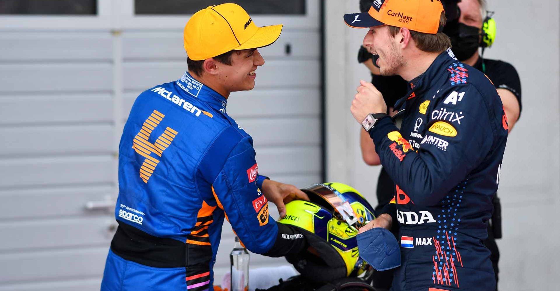 SPIELBERG, AUSTRIA - JULY 03: Pole position qualifier Max Verstappen of Netherlands and Red Bull Racing and second place qualifier Lando Norris of Great Britain and McLaren F1 talk in parc ferme during qualifying ahead of the F1 Grand Prix of Austria at Red Bull Ring on July 03, 2021 in Spielberg, Austria. (Photo by Christian Bruna - Pool/Getty Images)