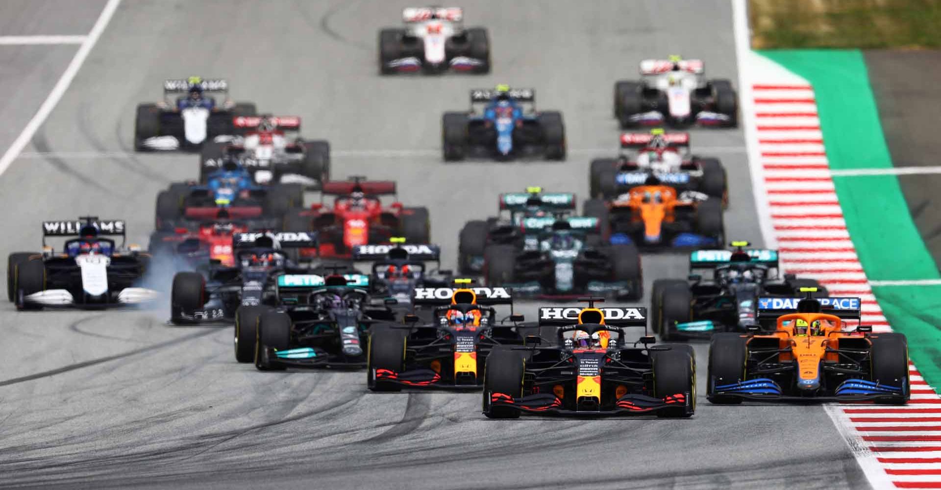 SPIELBERG, AUSTRIA - JULY 03: Max Verstappen of the Netherlands driving the (33) Red Bull Racing RB16B Honda leads the field into turn one at the start during qualifying ahead of the F1 Grand Prix of Austria at Red Bull Ring on July 03, 2021 in Spielberg, Austria. (Photo by Clive Rose/Getty Images)