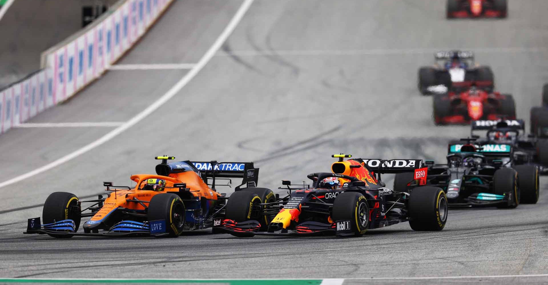 SPIELBERG, AUSTRIA - JULY 04: Sergio Perez of Mexico driving the (11) Red Bull Racing RB16B Honda and Lando Norris of Great Britain driving the (4) McLaren F1 Team MCL35M Mercedes battle for position during the F1 Grand Prix of Austria at Red Bull Ring on July 04, 2021 in Spielberg, Austria. (Photo by Clive Rose/Getty Images)