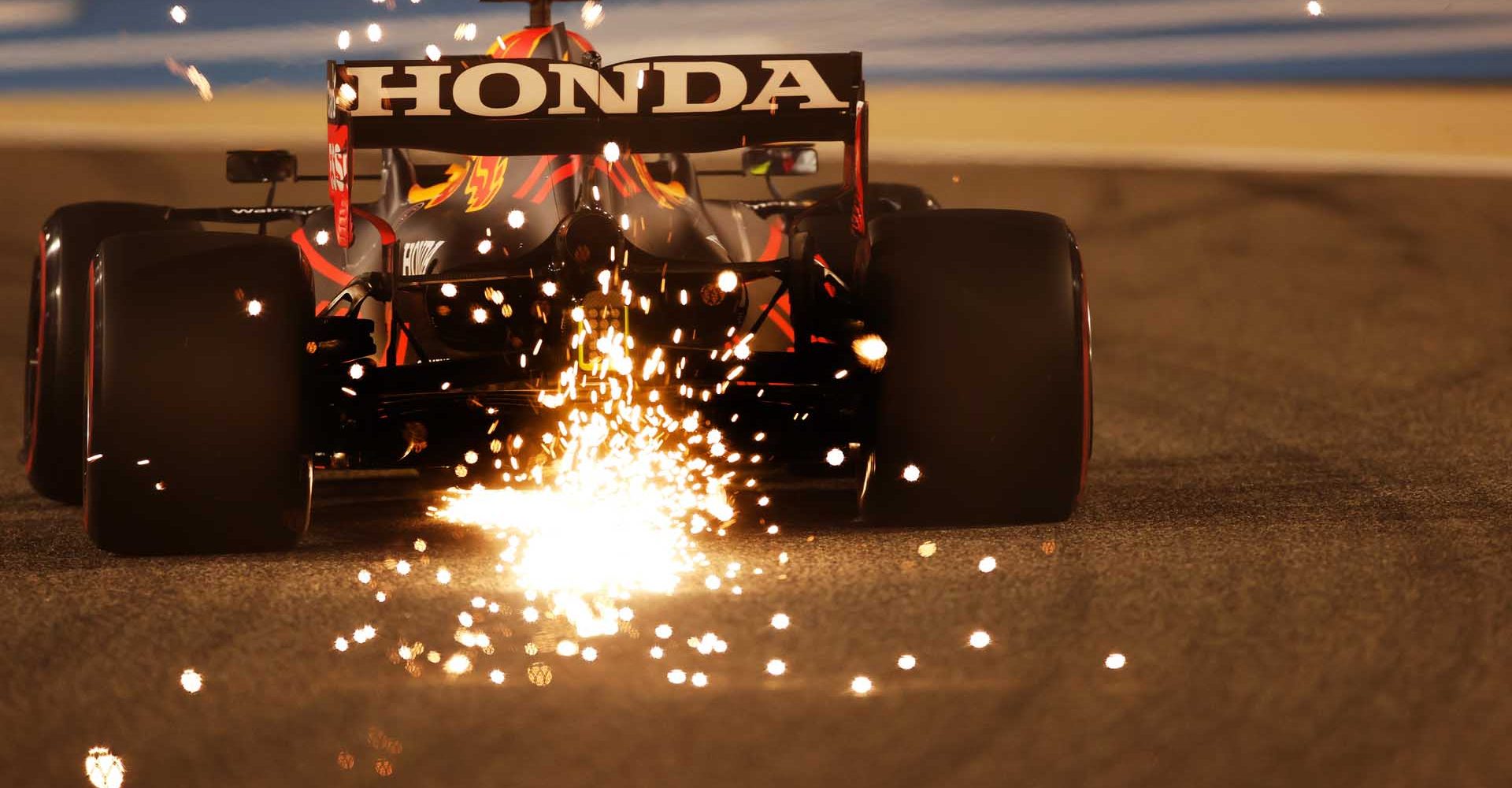 BAHRAIN, BAHRAIN - MARCH 26: Sparks fly behind Sergio Perez of Mexico driving the (11) Red Bull Racing RB16B Honda during practice ahead of the F1 Grand Prix of Bahrain at Bahrain International Circuit on March 26, 2021 in Bahrain, Bahrain. (Photo by Lars Baron/Getty Images)