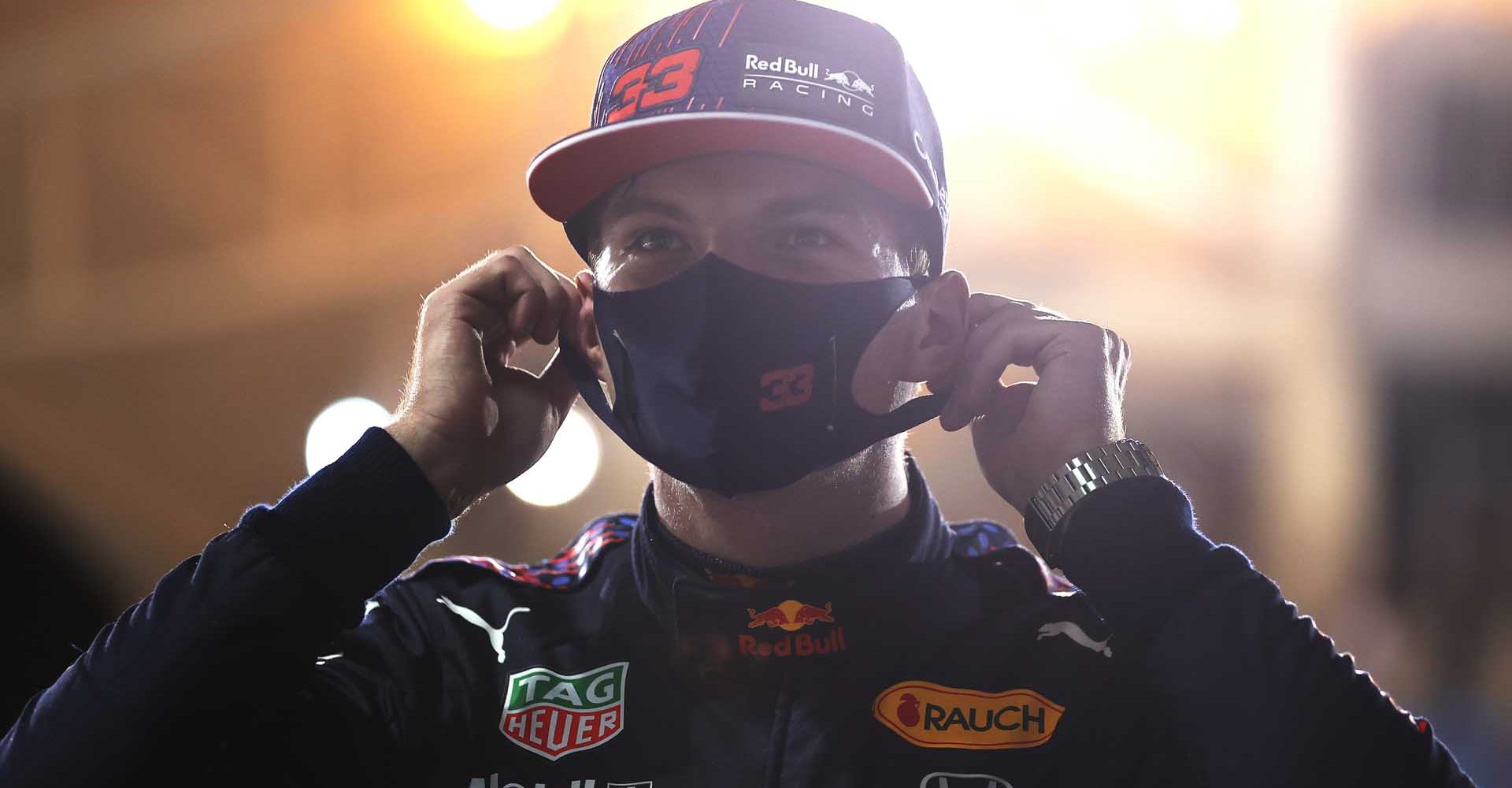 BAHRAIN, BAHRAIN - MARCH 27: Pole position qualifier Max Verstappen of Netherlands and Red Bull Racing puts a face mask on in parc ferme during qualifying ahead of the F1 Grand Prix of Bahrain at Bahrain International Circuit on March 27, 2021 in Bahrain, Bahrain. (Photo by Lars Baron/Getty Images)