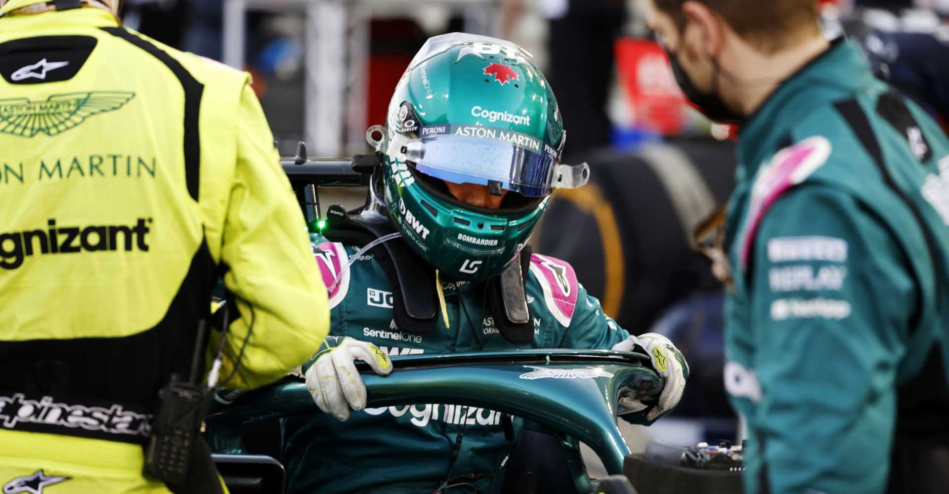 Lance Stroll, Aston Martin, climbs out of his car on the grid