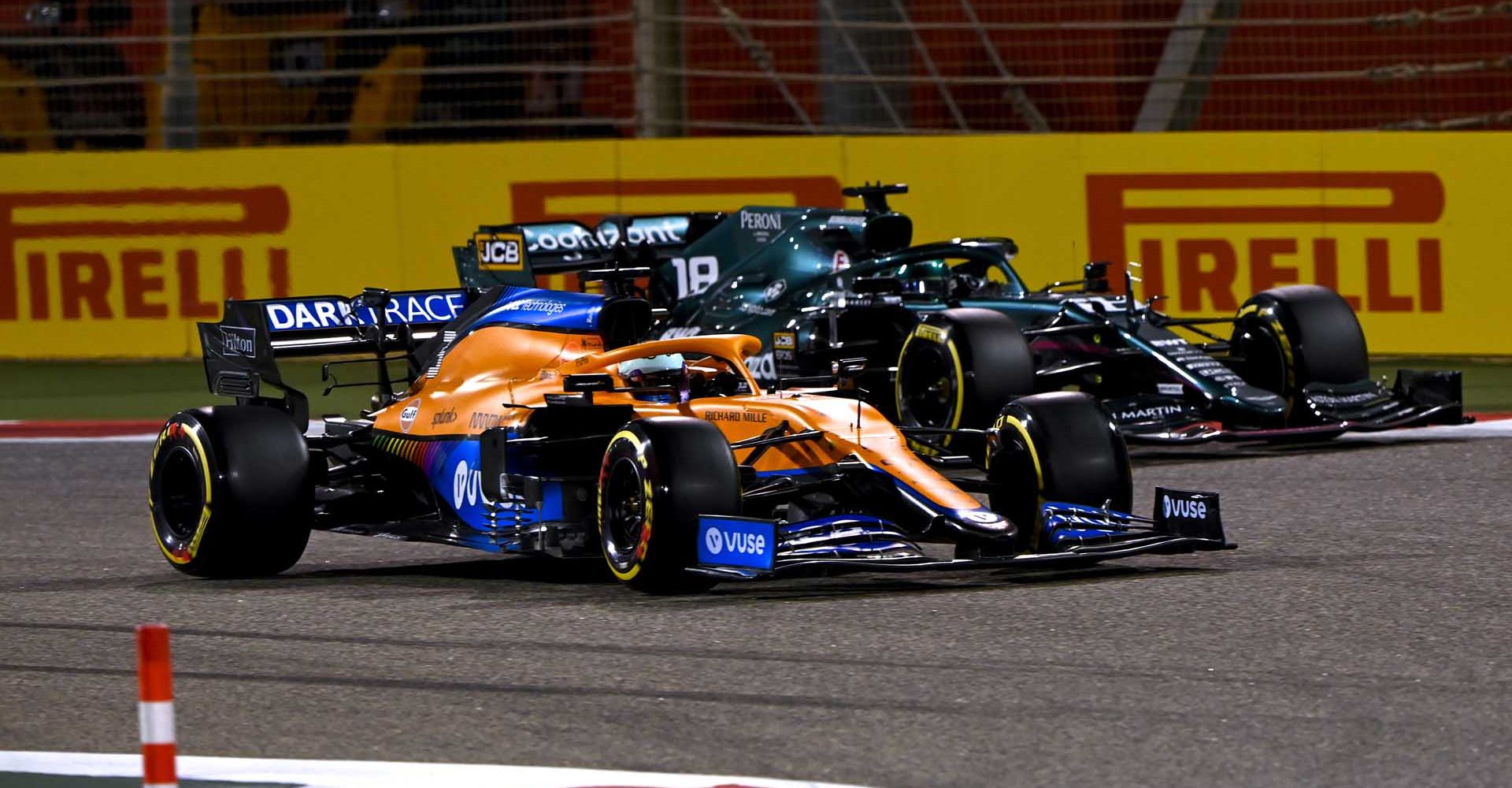 BAHRAIN INTERNATIONAL CIRCUIT, BAHRAIN - MARCH 28: Daniel Ricciardo, McLaren MCL35M, battles with Lance Stroll, Aston Martin AMR21 during the Bahrain GP at Bahrain International Circuit on Sunday March 28, 2021 in Sakhir, Bahrain. (Photo by Mark Sutton / LAT Images)