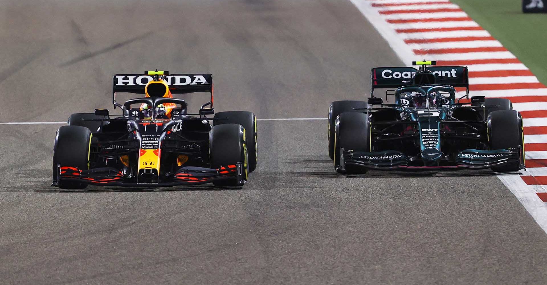 BAHRAIN, BAHRAIN - MARCH 28: Sergio Perez of Mexico driving the (11) Red Bull Racing RB16B Honda and Sebastian Vettel of Germany driving the (5) Aston Martin AMR21 Mercedes compete for position on track during the F1 Grand Prix of Bahrain at Bahrain International Circuit on March 28, 2021 in Bahrain, Bahrain. (Photo by Bryn Lennon/Getty Images)