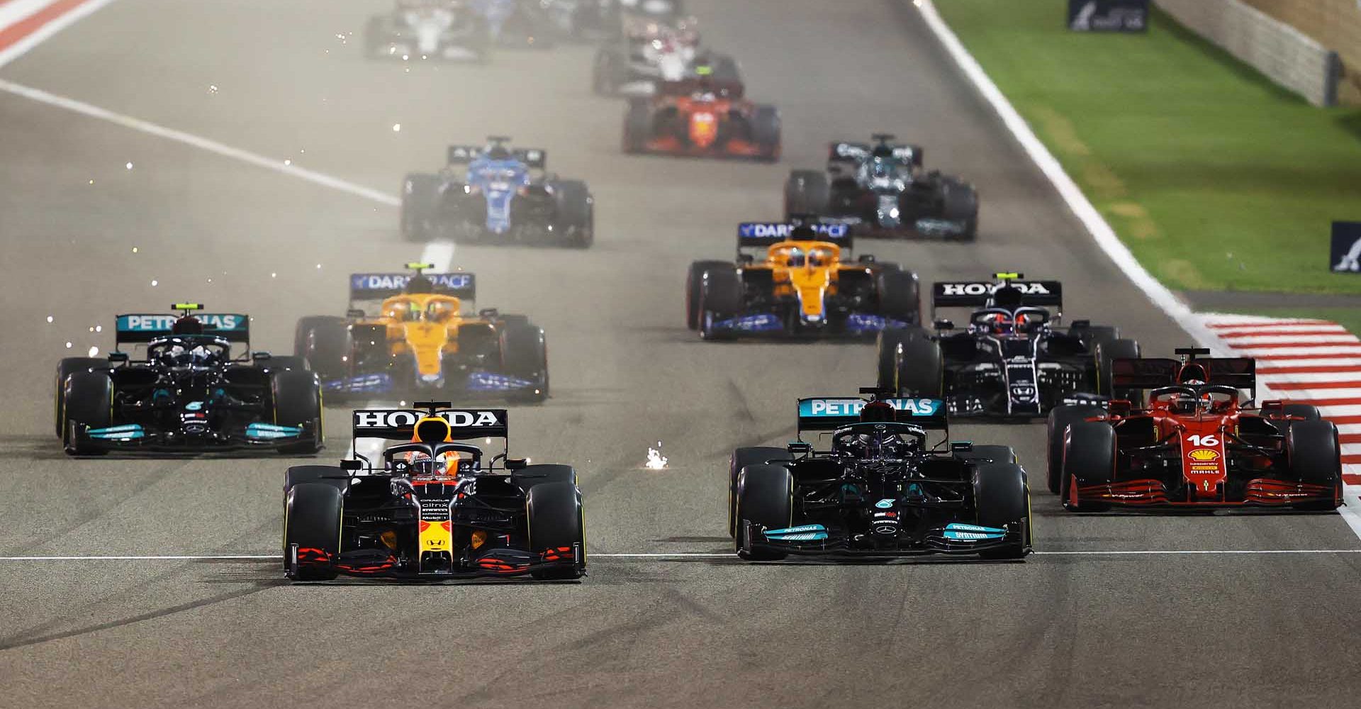 BAHRAIN, BAHRAIN - MARCH 28: Max Verstappen of the Netherlands driving the (33) Red Bull Racing RB16B Honda and Lewis Hamilton of Great Britain driving the (44) Mercedes AMG Petronas F1 Team Mercedes W12 compete for position on track during the F1 Grand Prix of Bahrain at Bahrain International Circuit on March 28, 2021 in Bahrain, Bahrain. (Photo by Bryn Lennon/Getty Images)