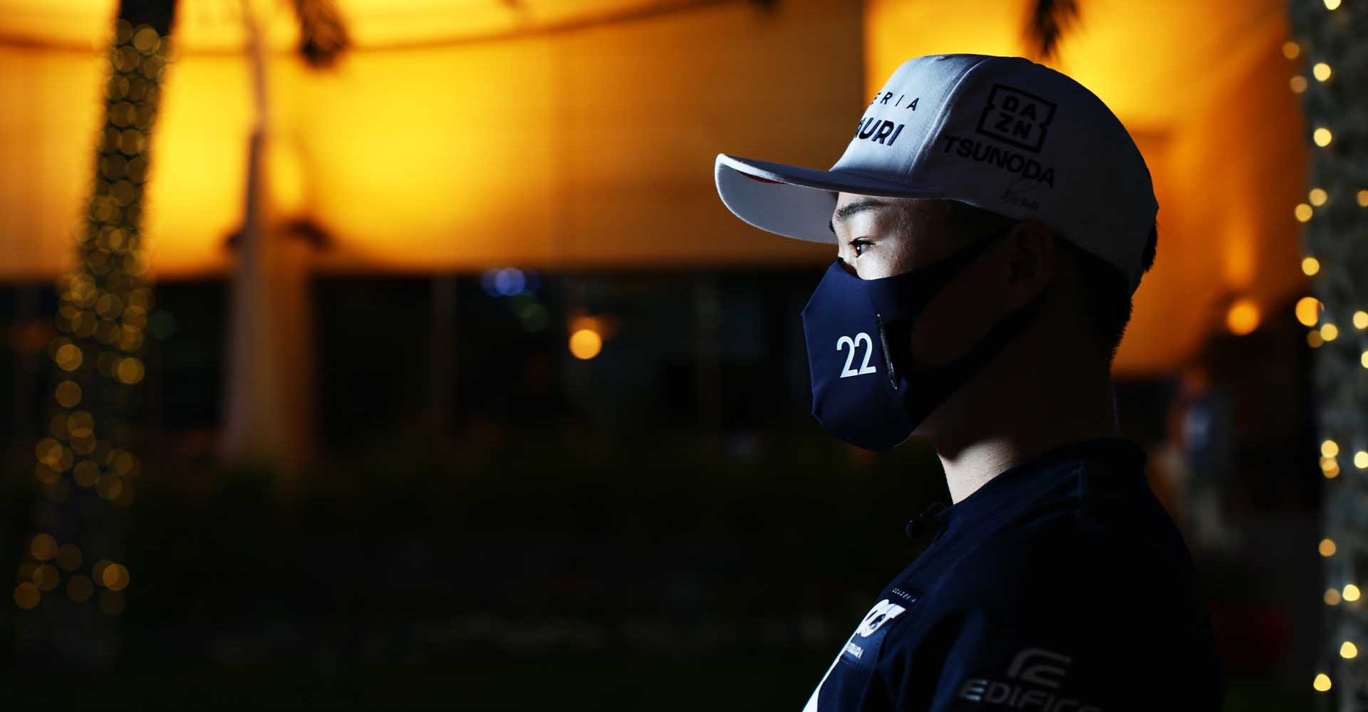 BAHRAIN, BAHRAIN - MARCH 25: Yuki Tsunoda of Japan and Scuderia AlphaTauri is interviewed in the Paddock during previews ahead of the F1 Grand Prix of Bahrain at Bahrain International Circuit on March 25, 2021 in Bahrain, Bahrain. (Photo by Peter Fox/Getty Images)