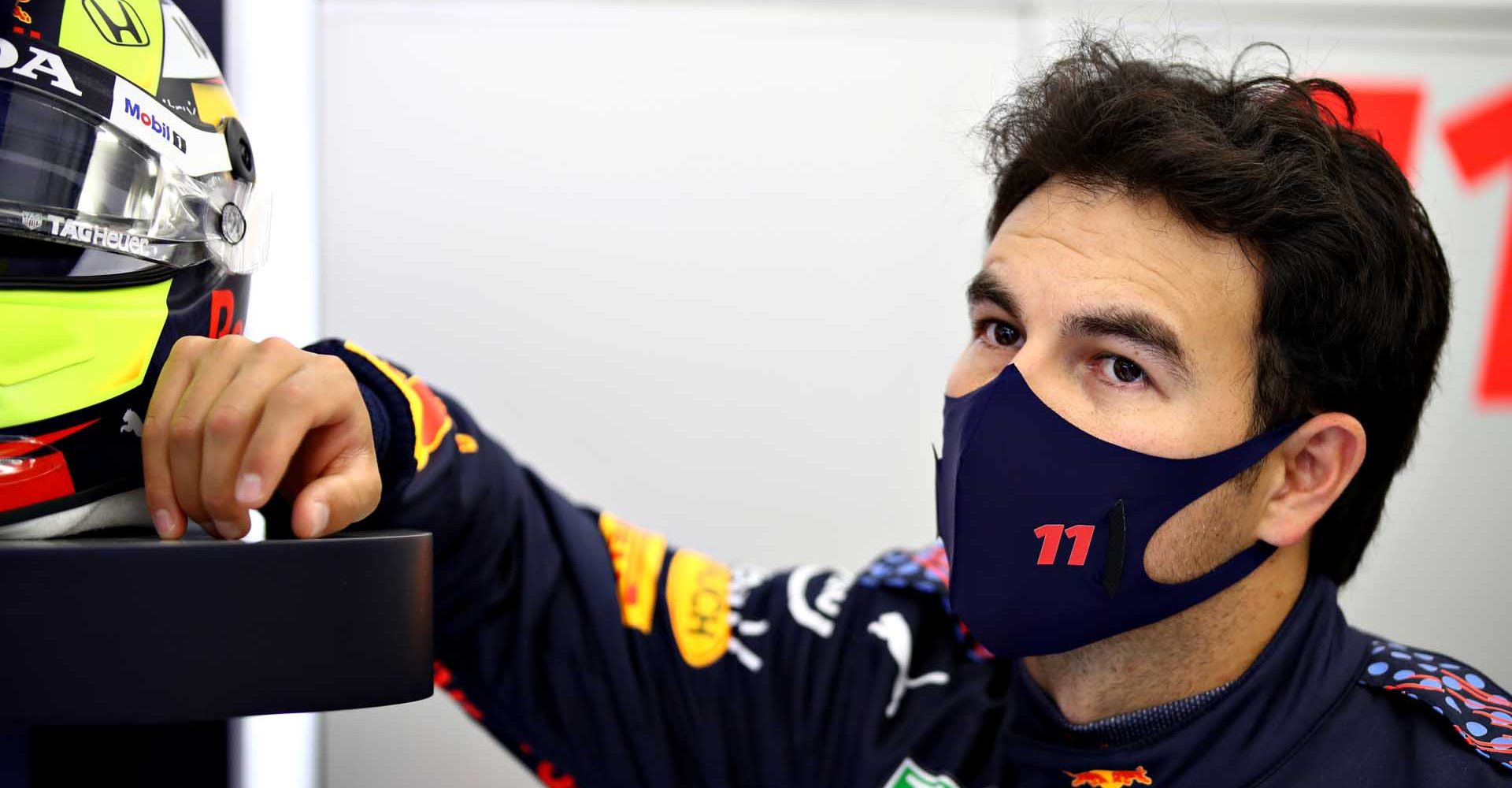 BAHRAIN, BAHRAIN - MARCH 11: Sergio Perez of Mexico and Red Bull Racing looks on in the garage during previews ahead of Formula 1 Testing at Bahrain International Circuit on March 11, 2021 in Bahrain, Bahrain. (Photo by Mark Thompson/Getty Images)