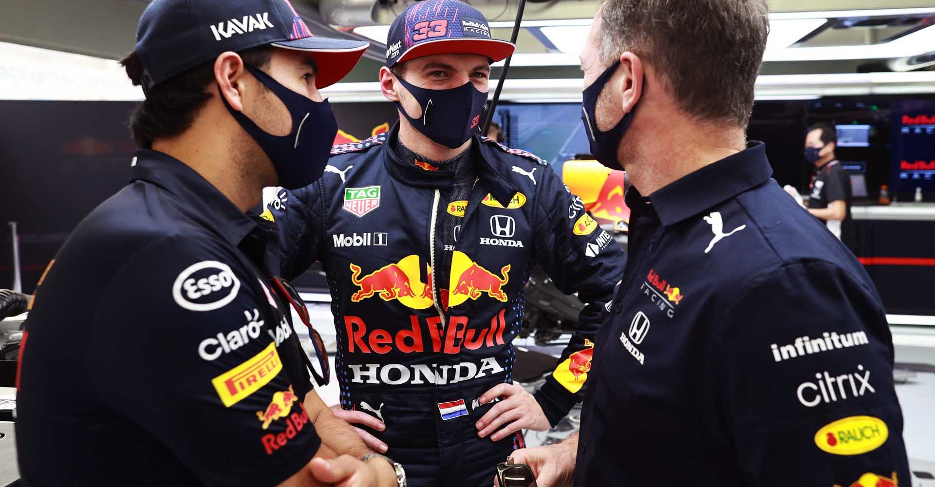 BAHRAIN, BAHRAIN - MARCH 12: Max Verstappen of Netherlands and Red Bull Racing talks with Sergio Perez of Mexico and Red Bull Racing and Red Bull Racing Team Principal Christian Horner in the garage during Day One of F1 Testing at Bahrain International Circuit on March 12, 2021 in Bahrain, Bahrain. (Photo by Mark Thompson/Getty Images) // Getty Images / Red Bull Content Pool  // SI202103121078 // Usage for editorial use only //