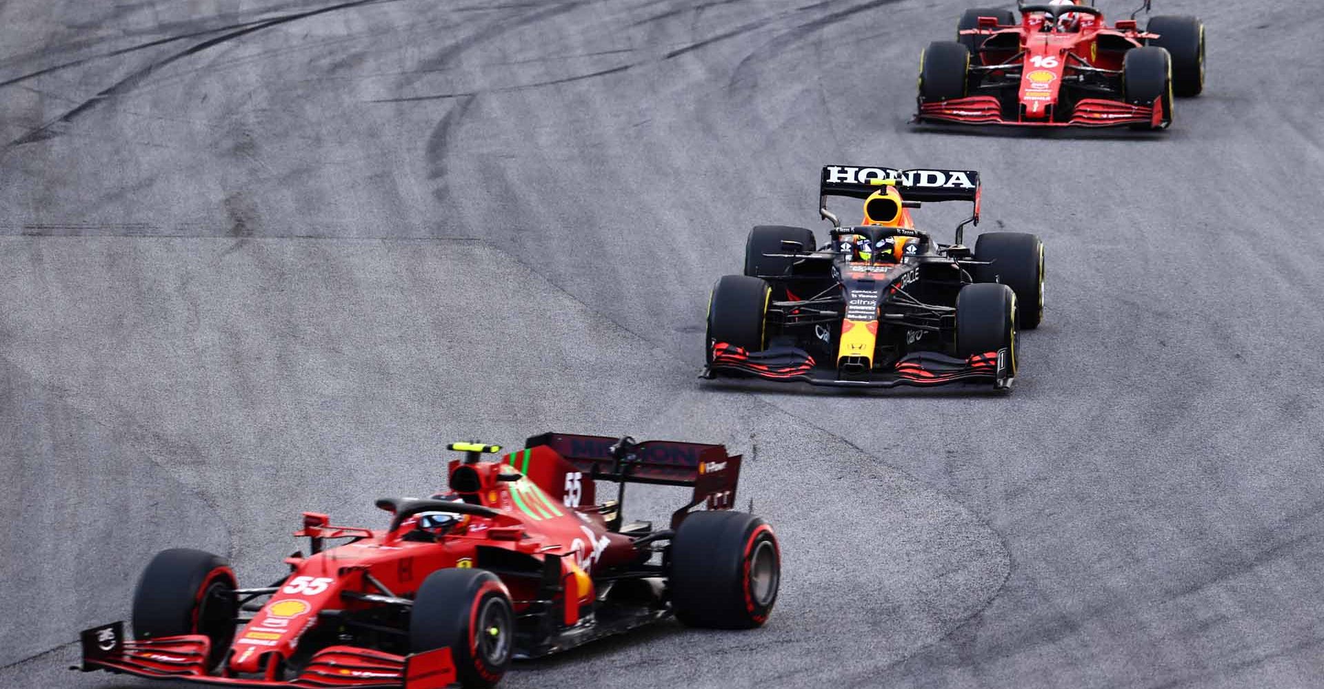 SAO PAULO, BRAZIL - NOVEMBER 13: Sergio Perez of Mexico driving the (11) Red Bull Racing RB16B Honda follows Carlos Sainz of Spain driving the (55) Scuderia Ferrari SF21 during the sprint ahead of the F1 Grand Prix of Brazil at Autodromo Jose Carlos Pace on November 13, 2021 in Sao Paulo, Brazil. (Photo by Mark Thompson/Getty Images)