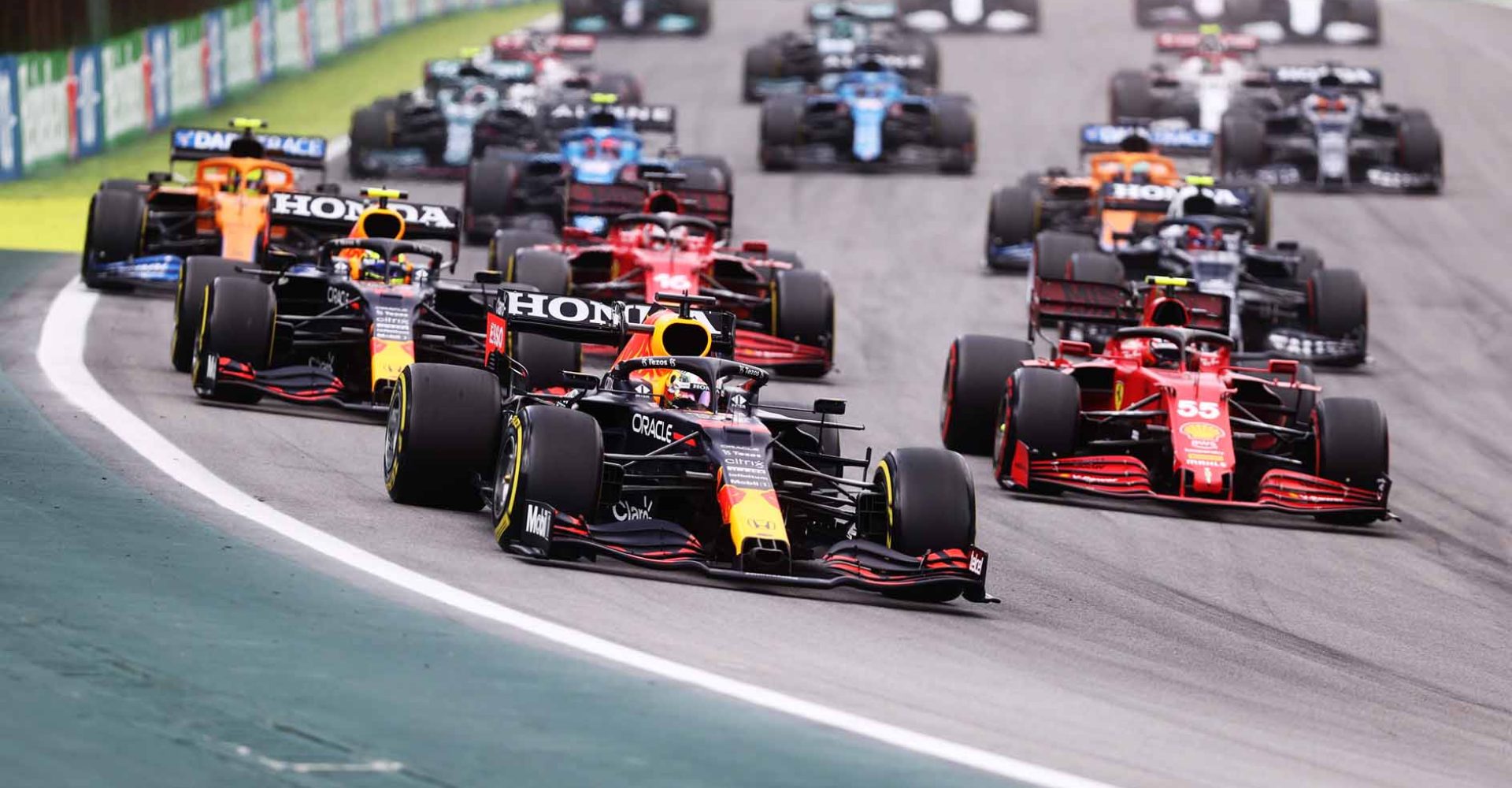 SAO PAULO, BRAZIL - NOVEMBER 13: Max Verstappen of the Netherlands driving the (33) Red Bull Racing RB16B Honda leads Sergio Perez of Mexico driving the (11) Red Bull Racing RB16B Honda and Carlos Sainz of Spain driving the (55) Scuderia Ferrari SF21 and during the sprint ahead of the F1 Grand Prix of Brazil at Autodromo Jose Carlos Pace on November 13, 2021 in Sao Paulo, Brazil. (Photo by Lars Baron/Getty Images)