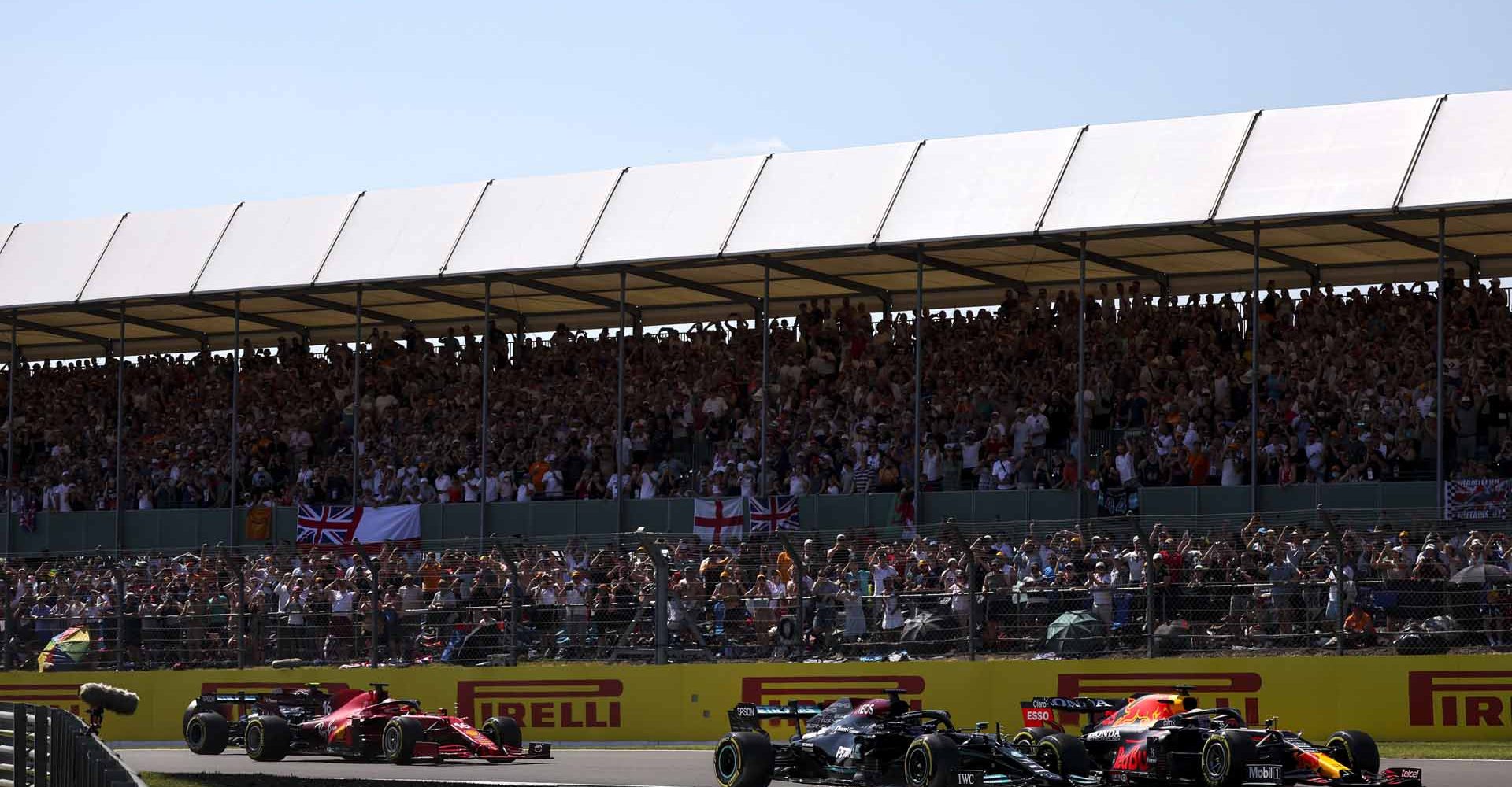 SILVERSTONE CIRCUIT, UNITED KINGDOM - JULY 18: Max Verstappen, Red Bull Racing RB16B, Sir Lewis Hamilton, Mercedes W12 and Charles Leclerc, Ferrari SF21 during the British GP at Silverstone Circuit on Sunday July 18, 2021 in Northamptonshire, United Kingdom. (Photo by Glenn Dunbar / LAT Images)