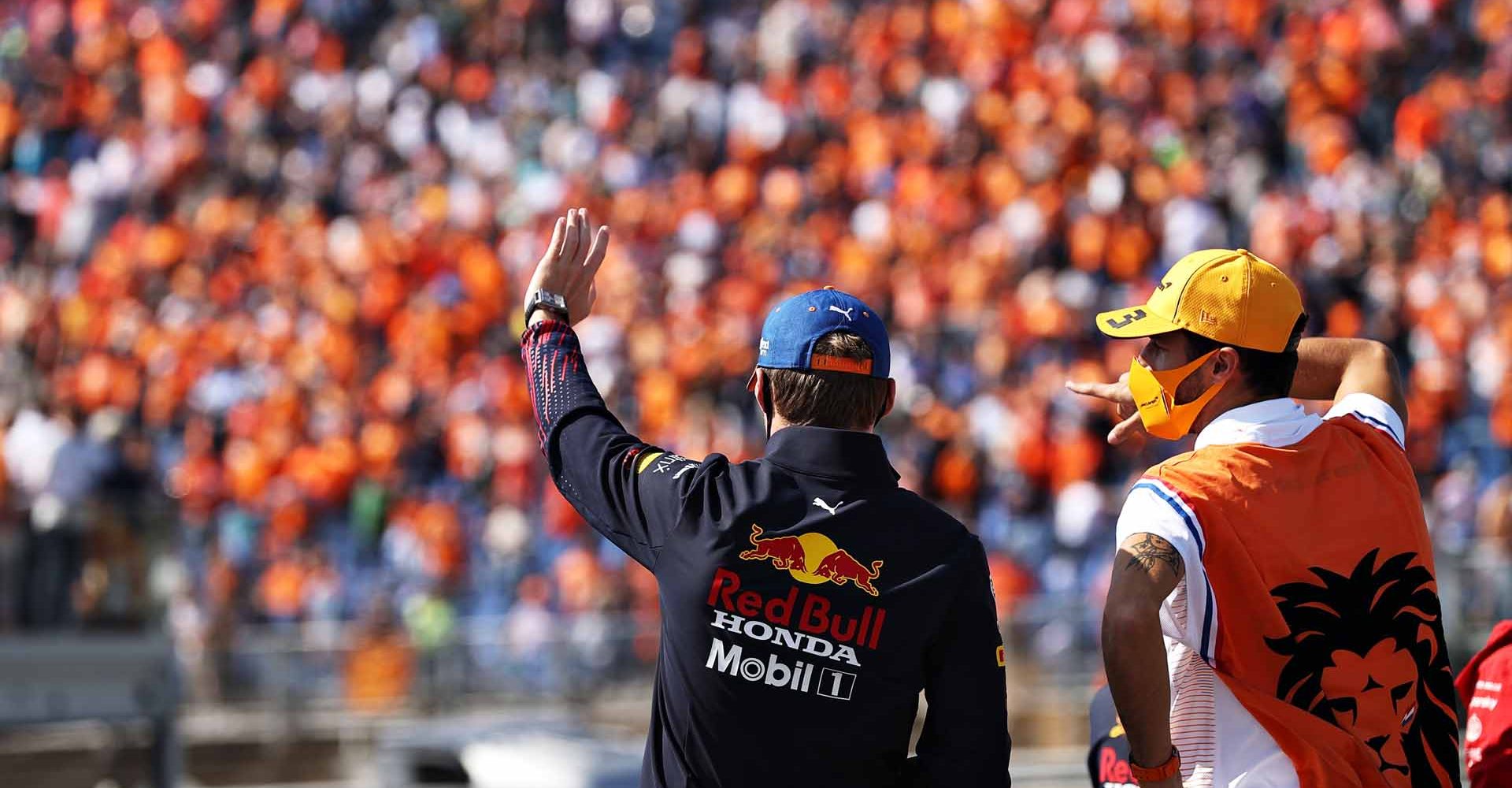 ZANDVOORT, NETHERLANDS - SEPTEMBER 05: Max Verstappen of Netherlands and Red Bull Racing and Daniel Ricciardo of Australia and McLaren F1 talk on the drivers parade ahead of the F1 Grand Prix of The Netherlands at Circuit Zandvoort on September 05, 2021 in Zandvoort, Netherlands. (Photo by Lars Baron/Getty Images)