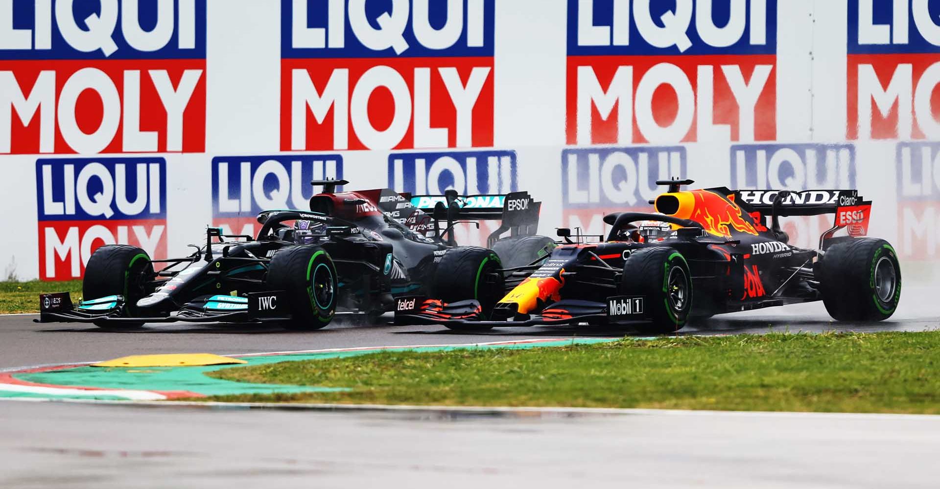 IMOLA, ITALY - APRIL 18: Lewis Hamilton of Great Britain driving the (44) Mercedes AMG Petronas F1 Team Mercedes W12 and Max Verstappen of the Netherlands driving the (33) Red Bull Racing RB16B Honda compete for position on track during the F1 Grand Prix of Emilia Romagna at Autodromo Enzo e Dino Ferrari on April 18, 2021 in Imola, Italy. (Photo by Bryn Lennon/Getty Images)