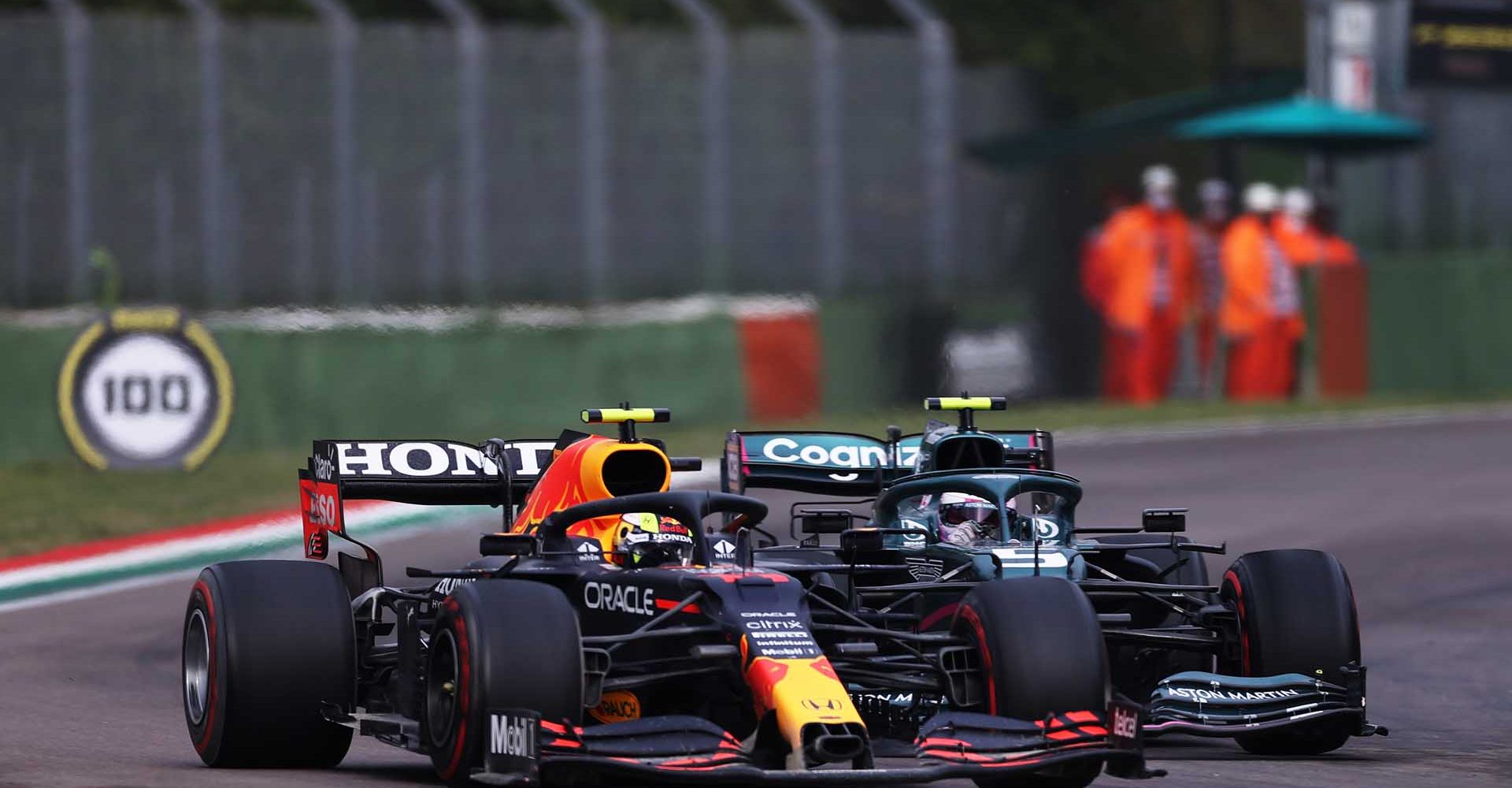 IMOLA, ITALY - APRIL 18: Sergio Perez of Mexico driving the (11) Red Bull Racing RB16B Honda and Sebastian Vettel of Germany driving the (5) Aston Martin AMR21 Mercedes compete for position on track during the F1 Grand Prix of Emilia Romagna at Autodromo Enzo e Dino Ferrari on April 18, 2021 in Imola, Italy. (Photo by Lars Baron/Getty Images)