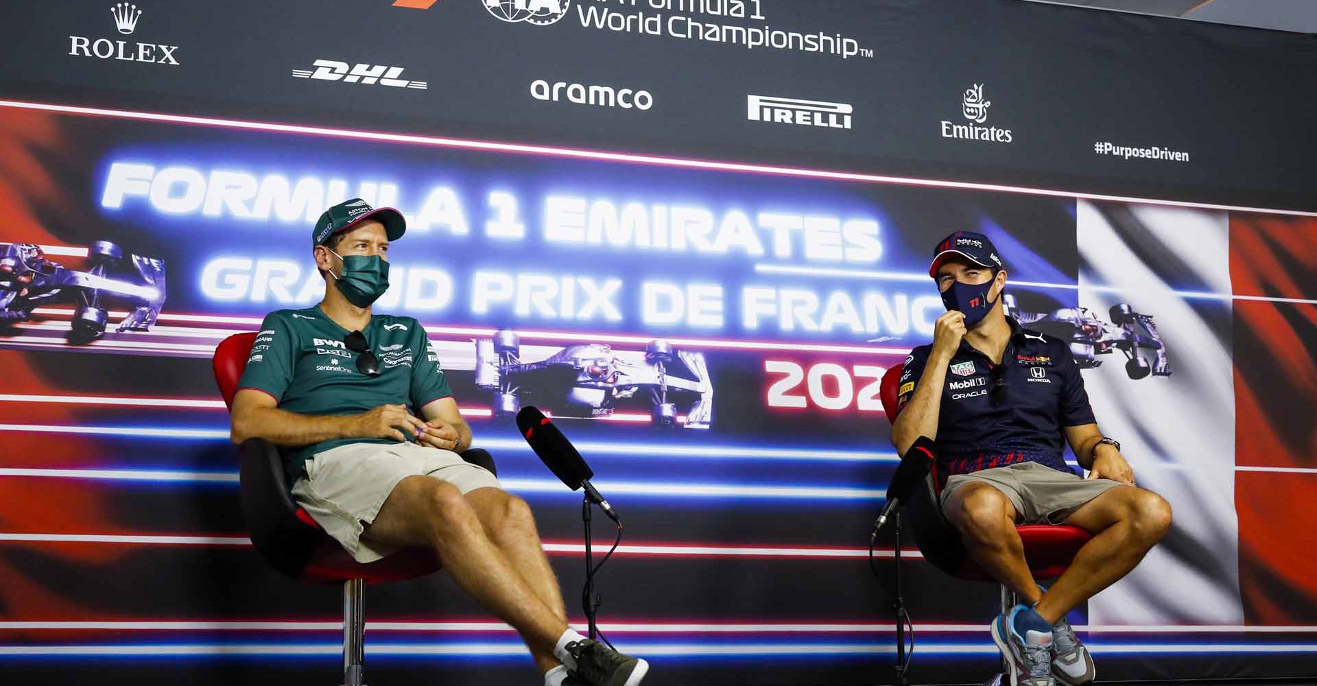 LE CASTELLET, FRANCE - JUNE 17: Sebastian Vettel of Germany and Aston Martin F1 Team and Sergio Perez of Mexico and Red Bull Racing talk in the Drivers Press Conference during previews ahead of the F1 Grand Prix of France at Circuit Paul Ricard on June 17, 2021 in Le Castellet, France. (Photo by Antonin Vincent - Pool/Getty Images)