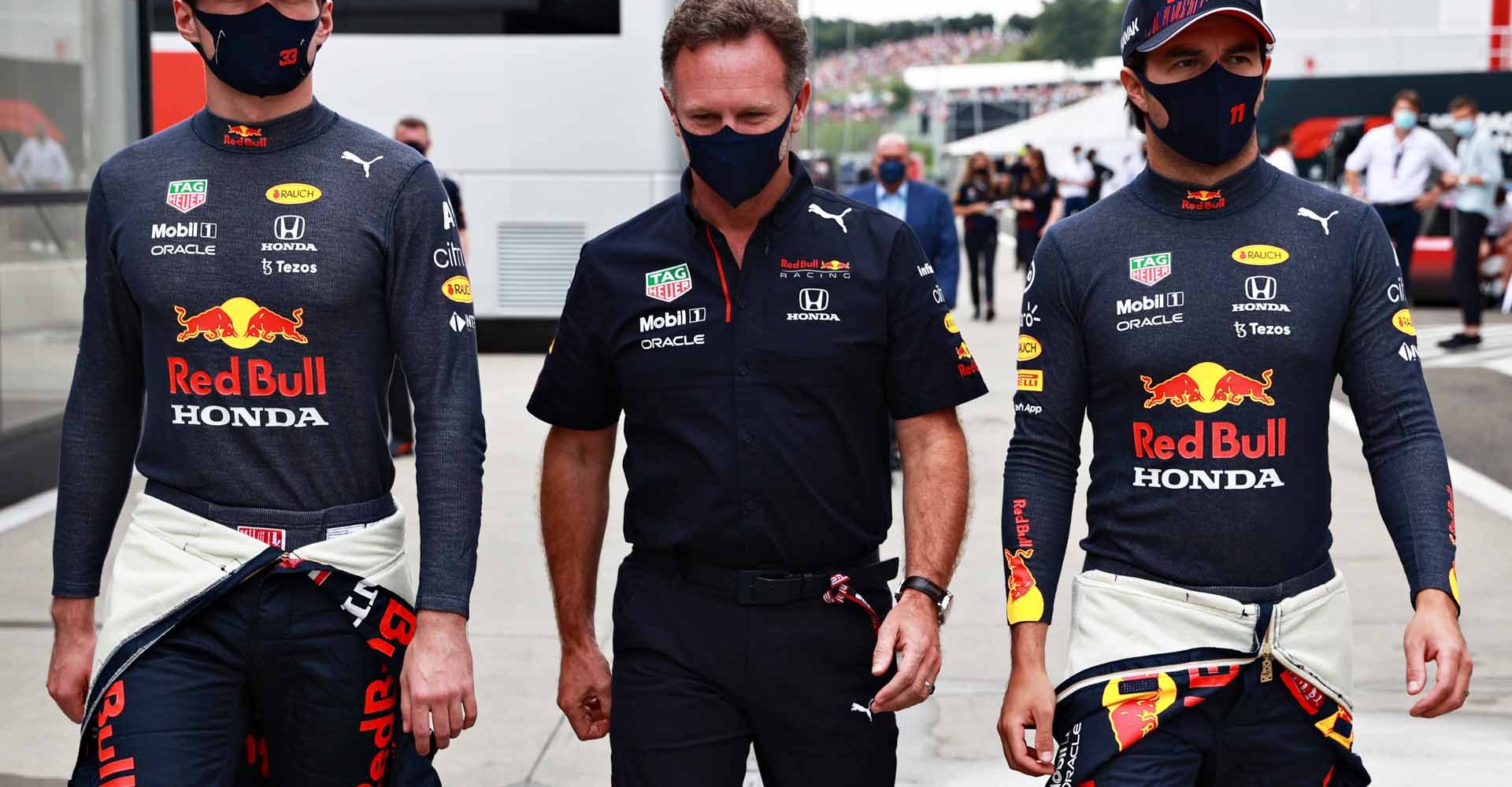 BUDAPEST, HUNGARY - AUGUST 01: Red Bull Racing Team Principal Christian Horner talks with Max Verstappen of Netherlands and Red Bull Racing and Sergio Perez of Mexico and Red Bull Racing in the Paddock before the F1 Grand Prix of Hungary at Hungaroring on August 01, 2021 in Budapest, Hungary. (Photo by Mark Thompson/Getty Images)