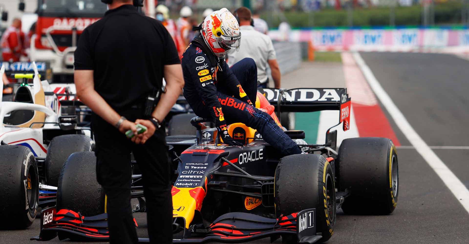 BUDAPEST, HUNGARY - AUGUST 01: Max Verstappen of Netherlands and Red Bull Racing climbs from his car in parc ferme during the F1 Grand Prix of Hungary at Hungaroring on August 01, 2021 in Budapest, Hungary. (Photo by Florion Goga - Pool/Getty Images)