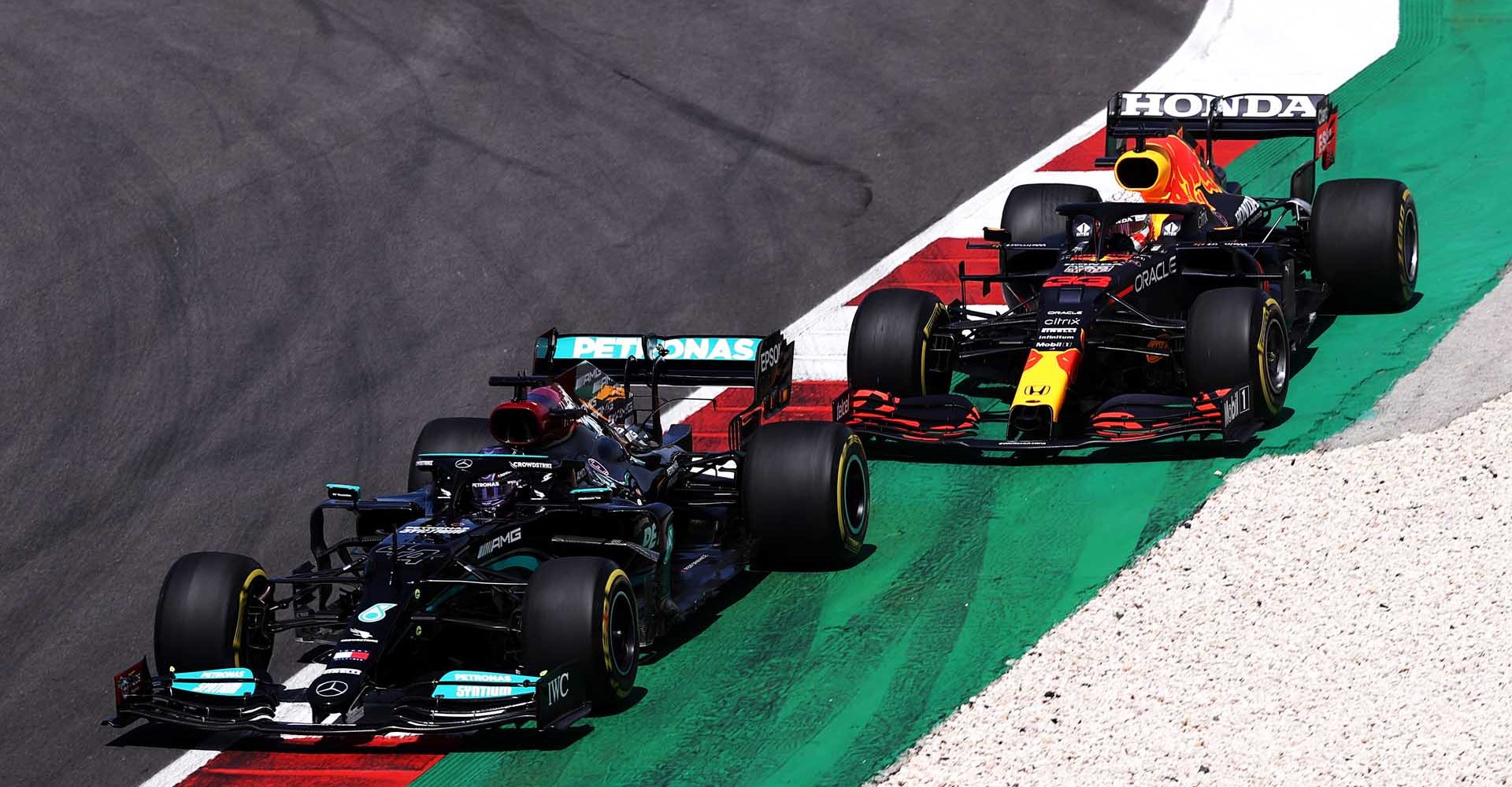 PORTIMAO, PORTUGAL - MAY 02: Lewis Hamilton of Great Britain driving the (44) Mercedes AMG Petronas F1 Team Mercedes W12 leads Max Verstappen of the Netherlands driving the (33) Red Bull Racing RB16B Honda during the F1 Grand Prix of Portugal at Autodromo Internacional Do Algarve on May 02, 2021 in Portimao, Portugal. (Photo by Lars Baron/Getty Images)