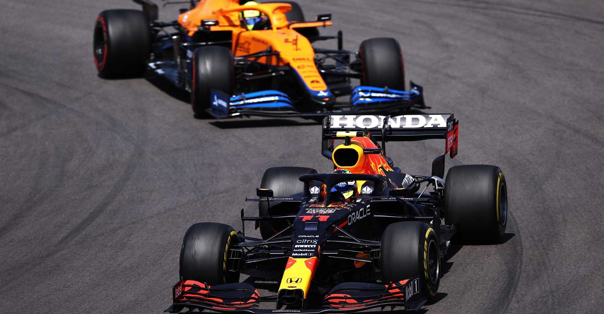 PORTIMAO, PORTUGAL - MAY 02: Sergio Perez of Mexico driving the (11) Red Bull Racing RB16B Honda leads Lando Norris of Great Britain driving the (4) McLaren F1 Team MCL35M Mercedes on track during the F1 Grand Prix of Portugal at Autodromo Internacional Do Algarve on May 02, 2021 in Portimao, Portugal. (Photo by Lars Baron/Getty Images)