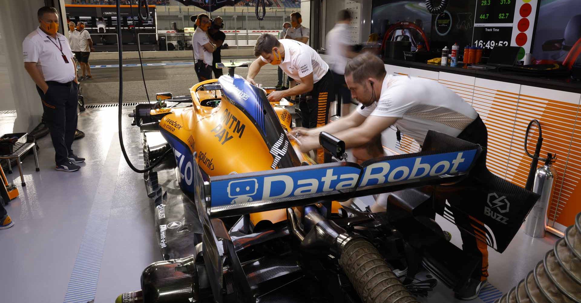 Mechanics work on the car of Lando Norris, McLaren MCL35M