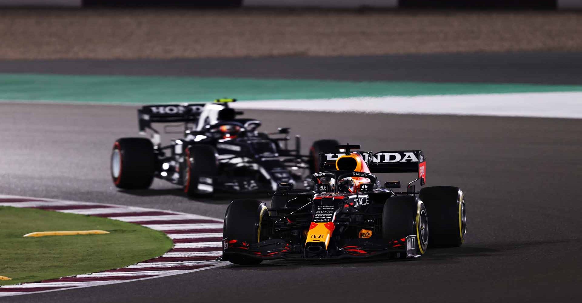 DOHA, QATAR - NOVEMBER 21: Max Verstappen of the Netherlands driving the (33) Red Bull Racing RB16B Honda leads Pierre Gasly of France driving the (10) Scuderia AlphaTauri AT02 Honda during the F1 Grand Prix of Qatar at Losail International Circuit on November 21, 2021 in Doha, Qatar. (Photo by Lars Baron/Getty Images)