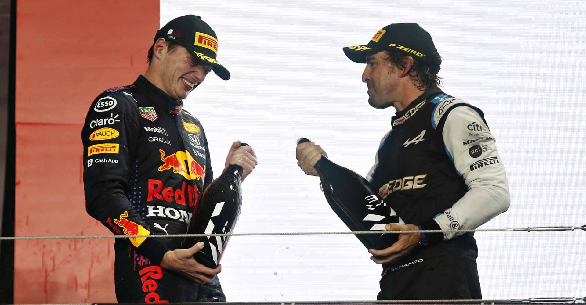 DOHA, QATAR - NOVEMBER 21: Second placed Max Verstappen of Netherlands and Red Bull Racing and third placed Fernando Alonso of Spain and Alpine F1 Team celebrate on the podium during the F1 Grand Prix of Qatar at Losail International Circuit on November 21, 2021 in Doha, Qatar. (Photo by Hamad I Mohammed - Pool/Getty Images)