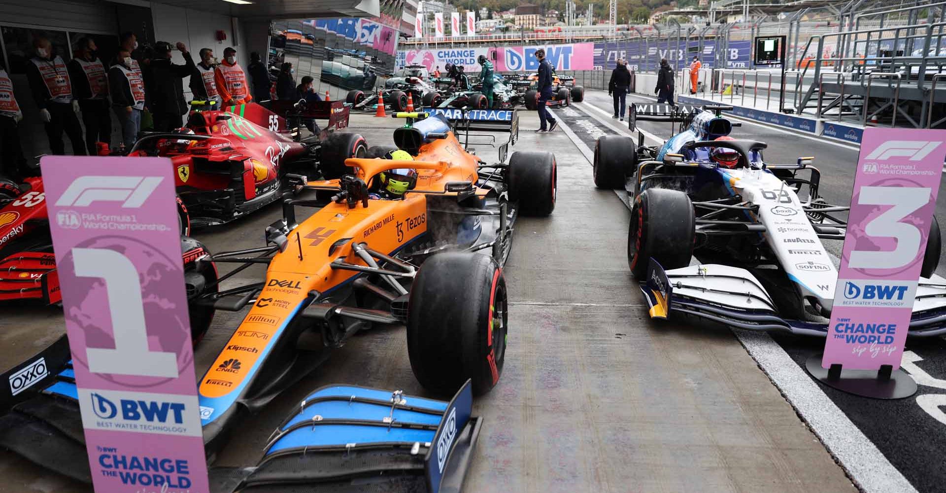 Carlos Sainz, Ferrari SF21, pole man Lando Norris, McLaren MCL35M, and George Russell, Williams FW43B, arrives in Parc Ferme after Qualifying head on