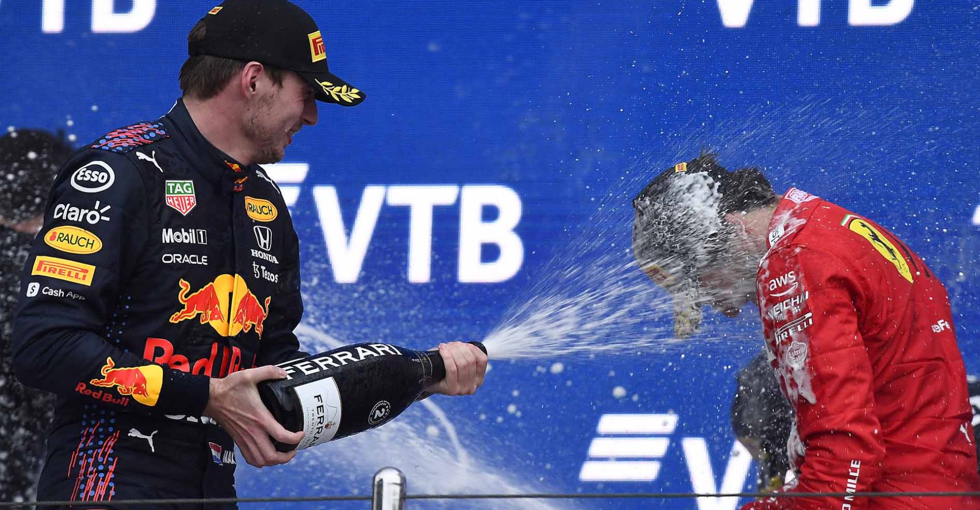 SOCHI, RUSSIA - SEPTEMBER 26: Second placed Max Verstappen of Netherlands and Red Bull Racing and third placed Carlos Sainz of Spain and Ferrari celebrate on the podium during the F1 Grand Prix of Russia at Sochi Autodrom on September 26, 2021 in Sochi, Russia. (Photo by Rudy Carezzevoli/Getty Images)