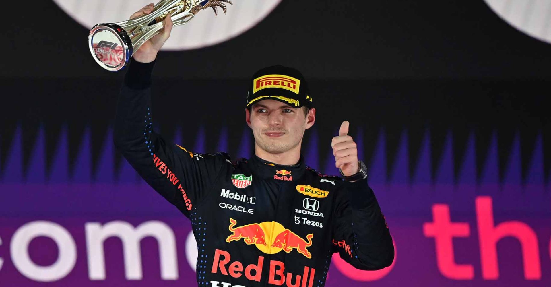 JEDDAH, SAUDI ARABIA - DECEMBER 05: Second placed Max Verstappen of Netherlands and Red Bull Racing celebrates on the podium during the F1 Grand Prix of Saudi Arabia at Jeddah Corniche Circuit on December 05, 2021 in Jeddah, Saudi Arabia. (Photo by Andrej Isakovic - Pool/Getty Images)